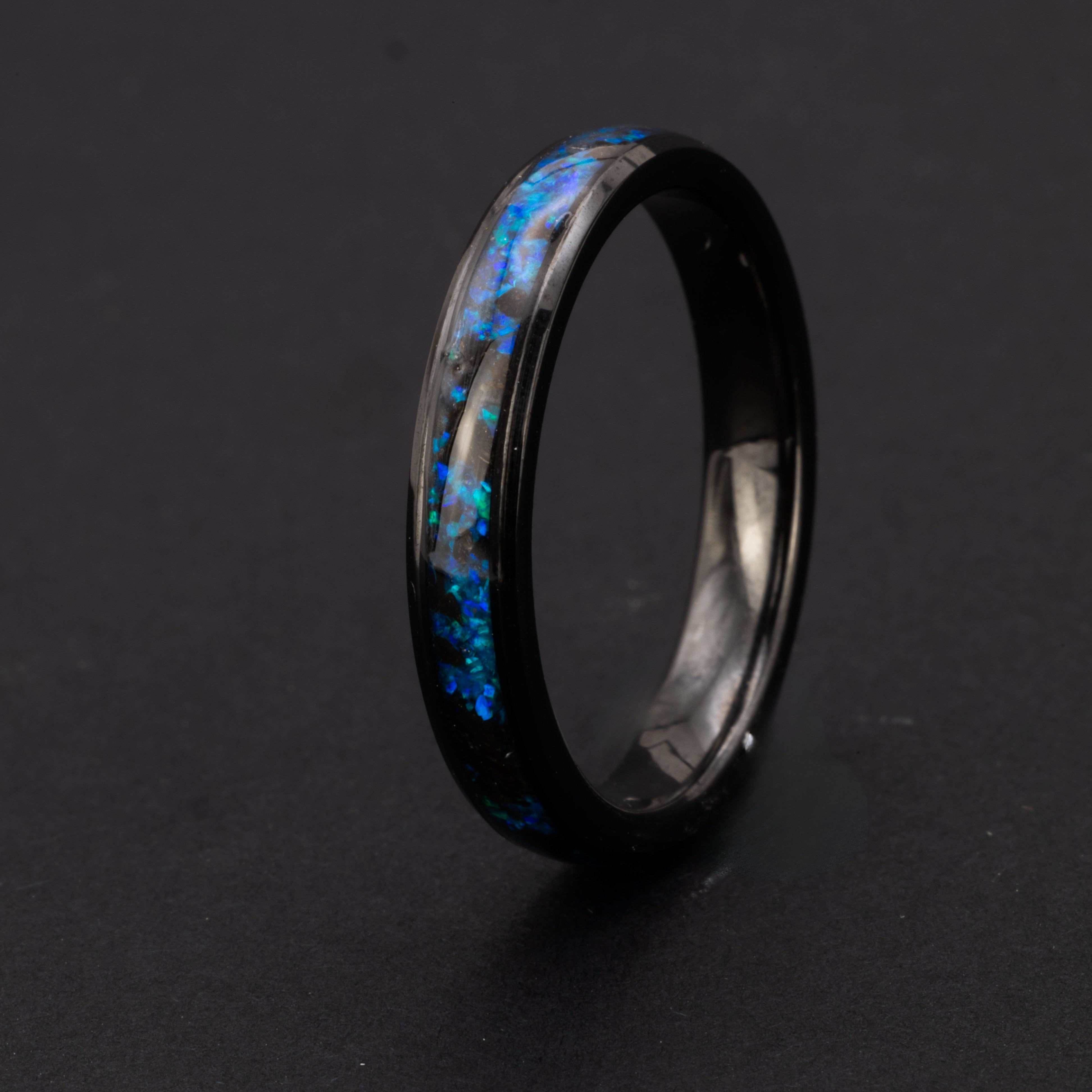 Handcrafted 4mm beveled black ceramic wedding band with authentic Megalodon tooth in blue opal blue glow inlay made in California
