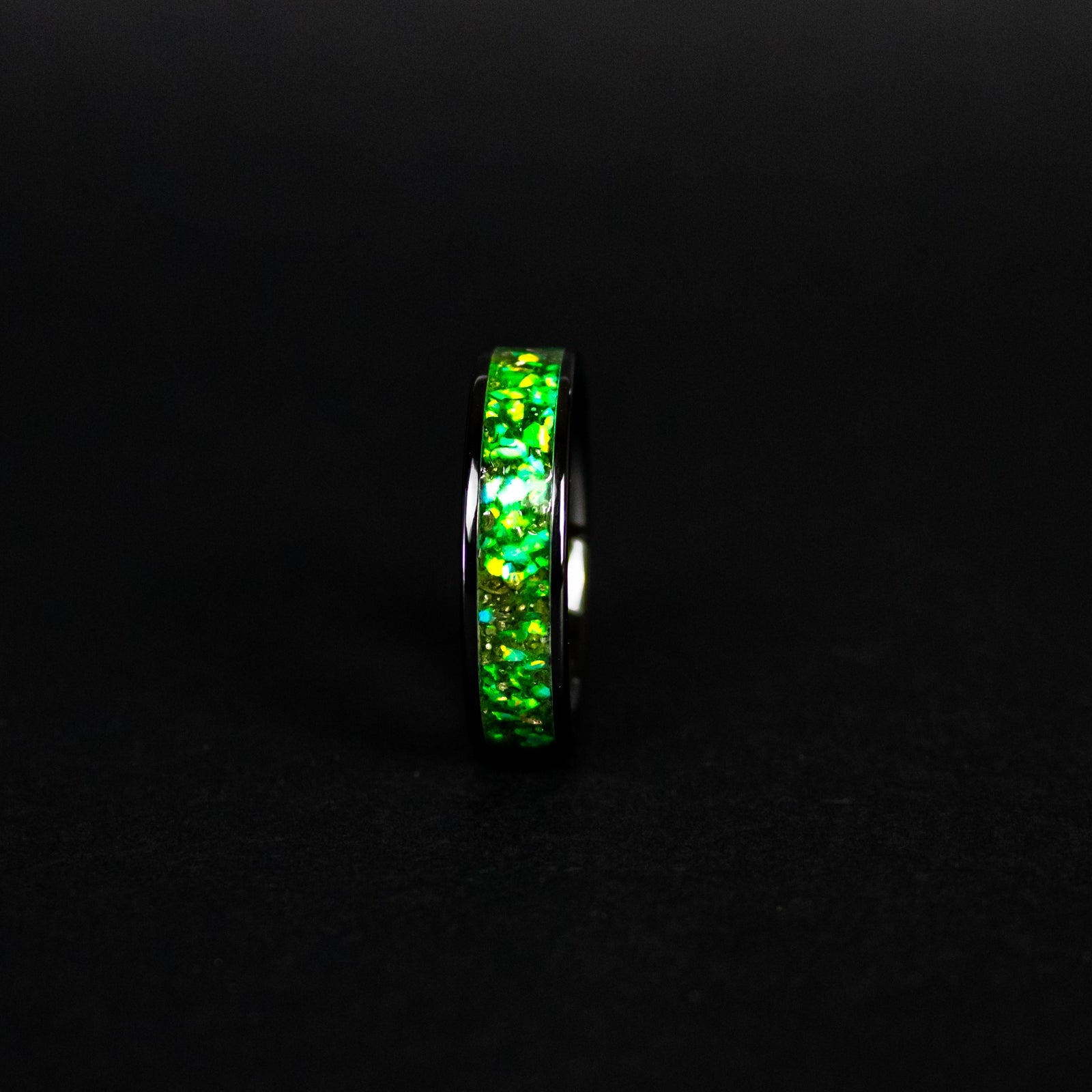 Handcrafted 6mm wide channel black ceramic mens wedding band with authentic Campo del Cielo meteorite in green opal green glow inlay made in California