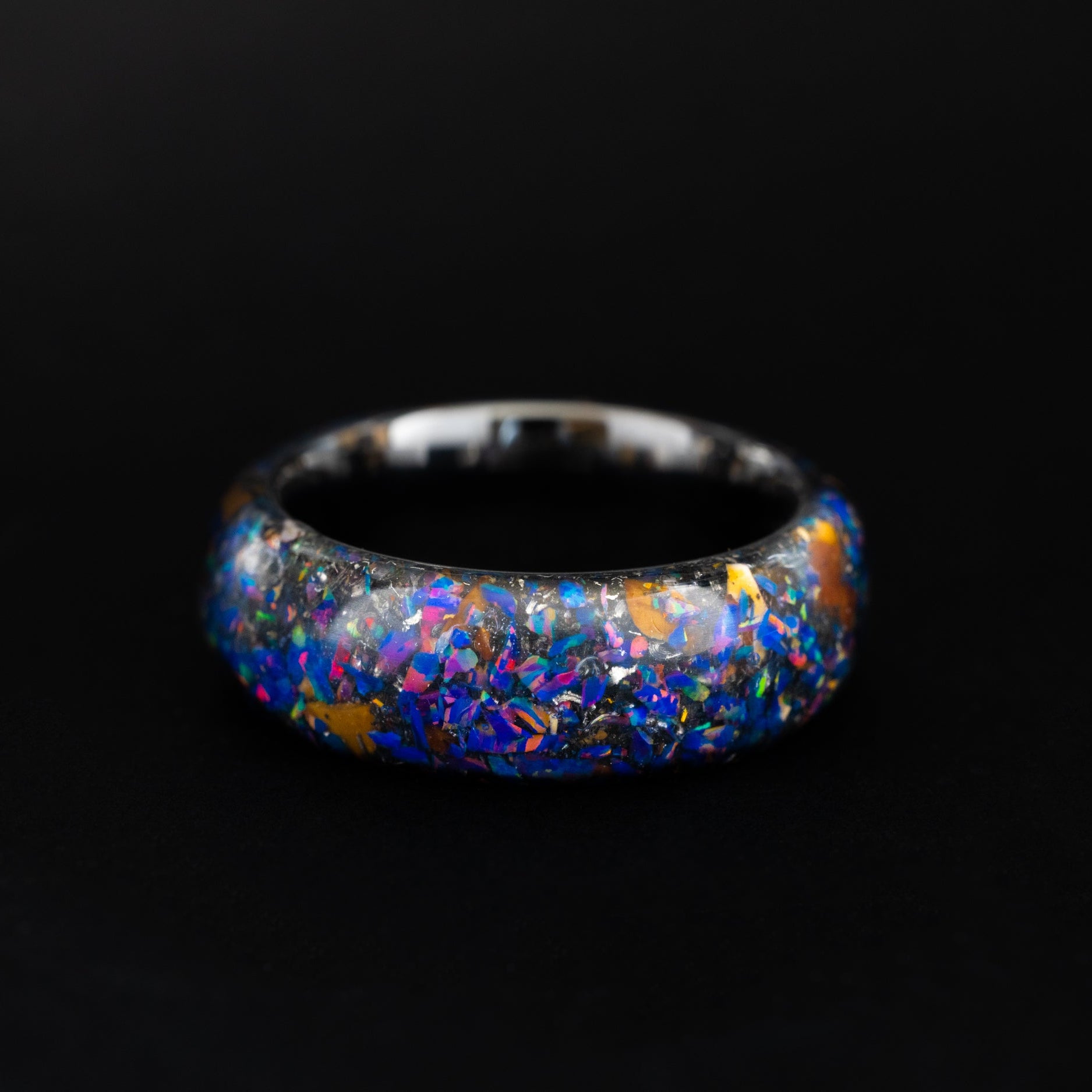 Handcrafted endless silver tungsten wedding band featuring prehistoric raptor bone and royal purple opal.