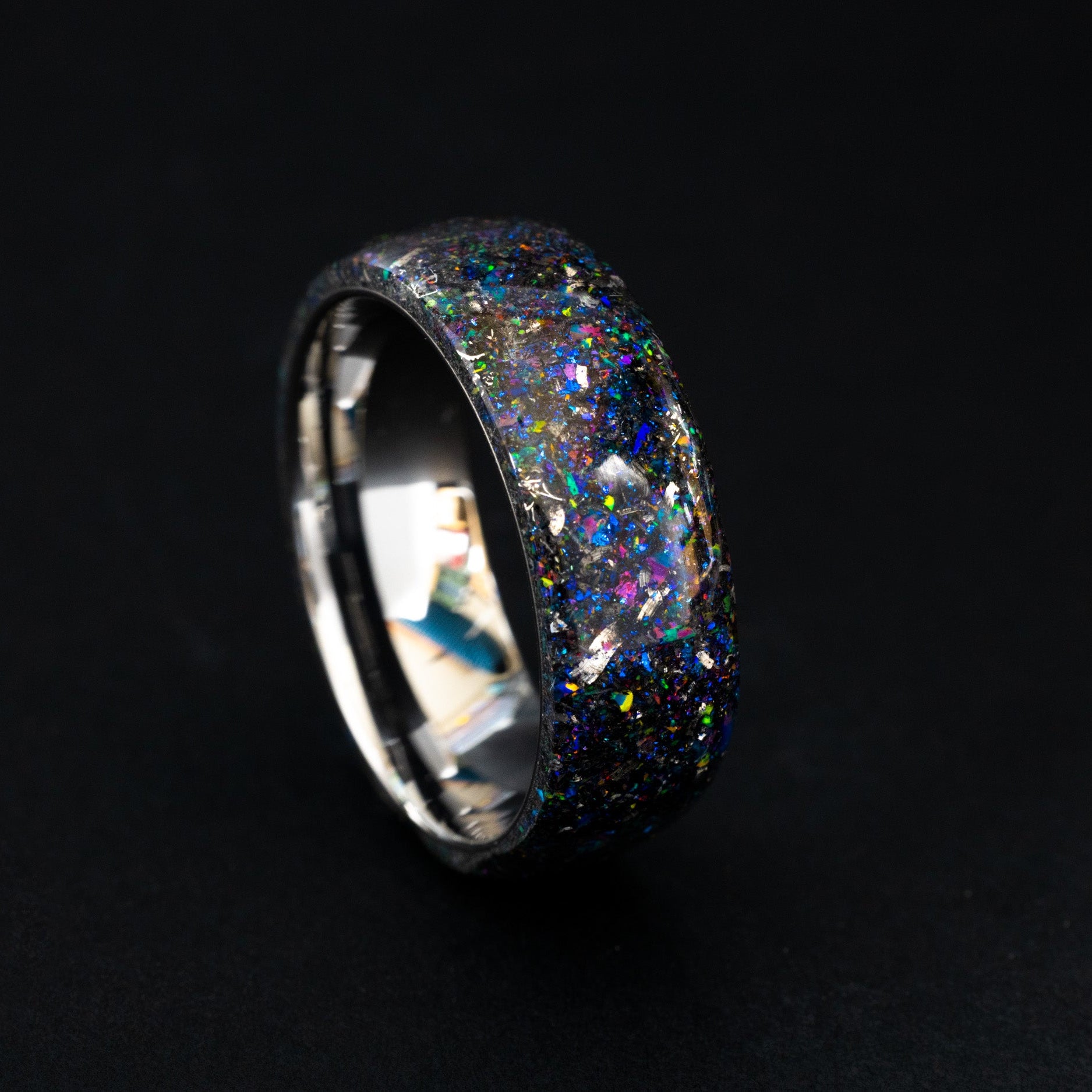 Handcrafted endless silver tungsten wedding band featuring celestial meteorite fragments and purple shimmer.
