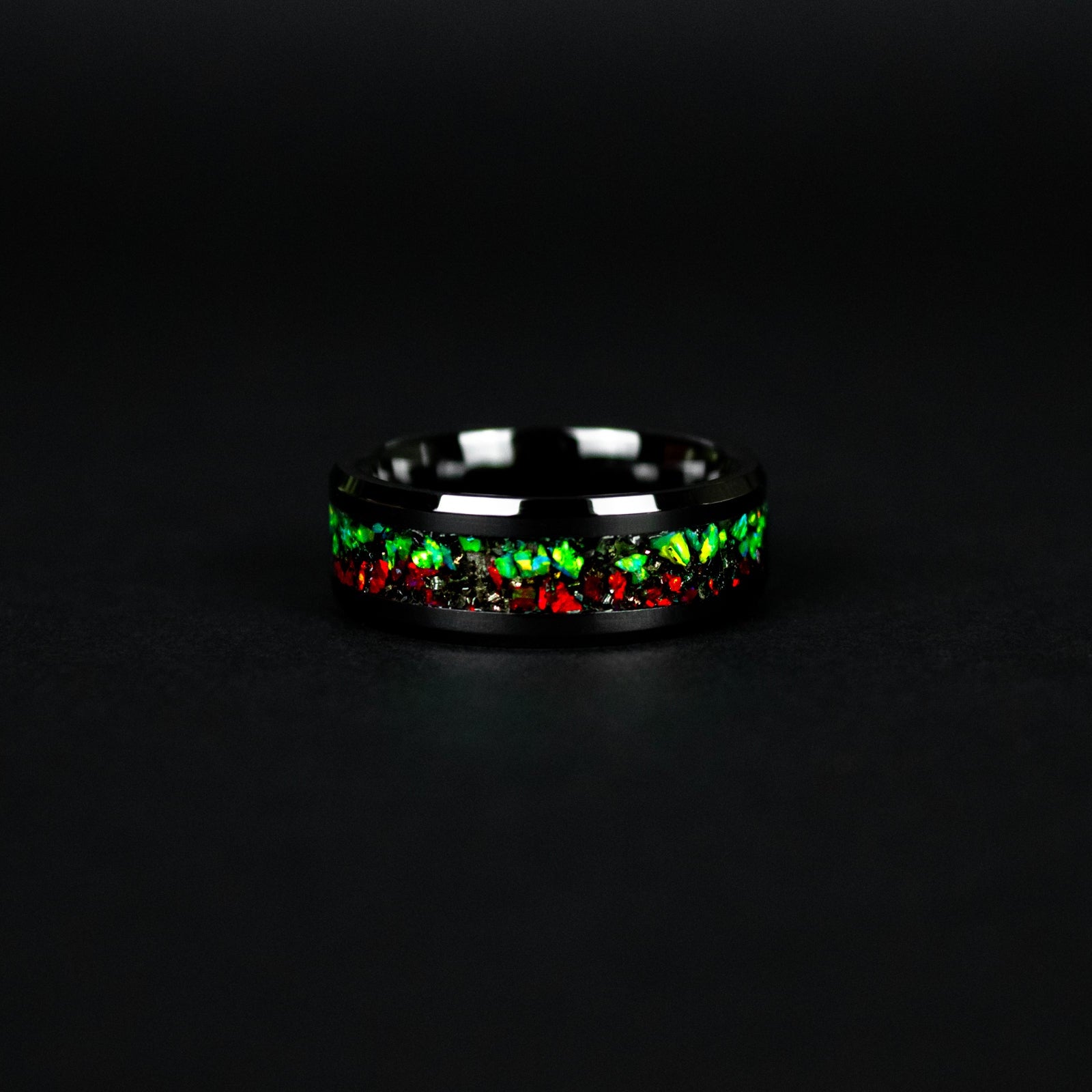 Handcrafted 8mm beveled black ceramic mens wedding band with authentic Campo del Cielo meteorite in split red and green opal inlay made in California
