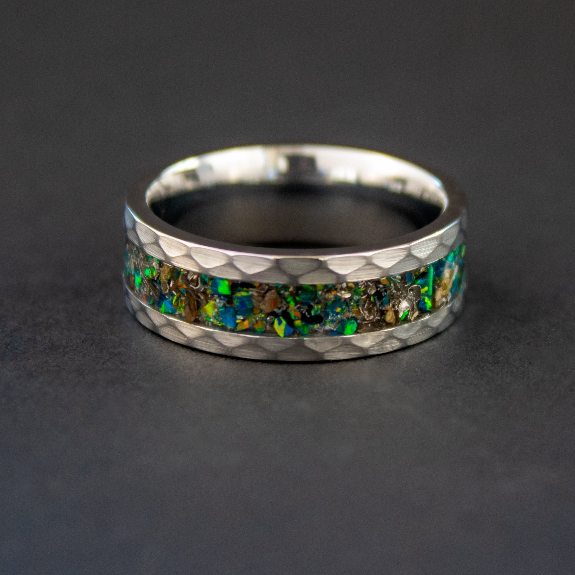 Handcrafted hammered tungsten mens wedding band with authentic T-Rex bone and Campo del Cielo meteorite in green opal inlay made in California