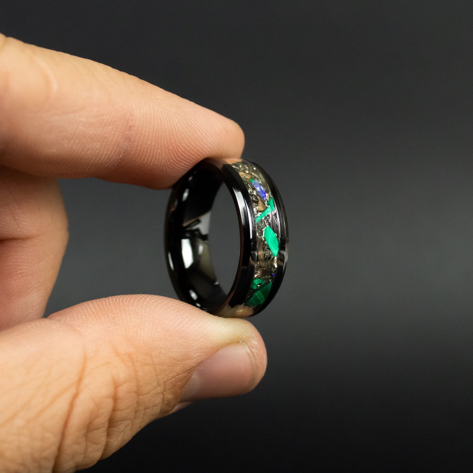 Handcrafted 8mm beveled black ceramic mens wedding band with authentic T-Rex bone, Campo del Cielo meteorite, malachite, and Ethiopian Opal inlay made in California