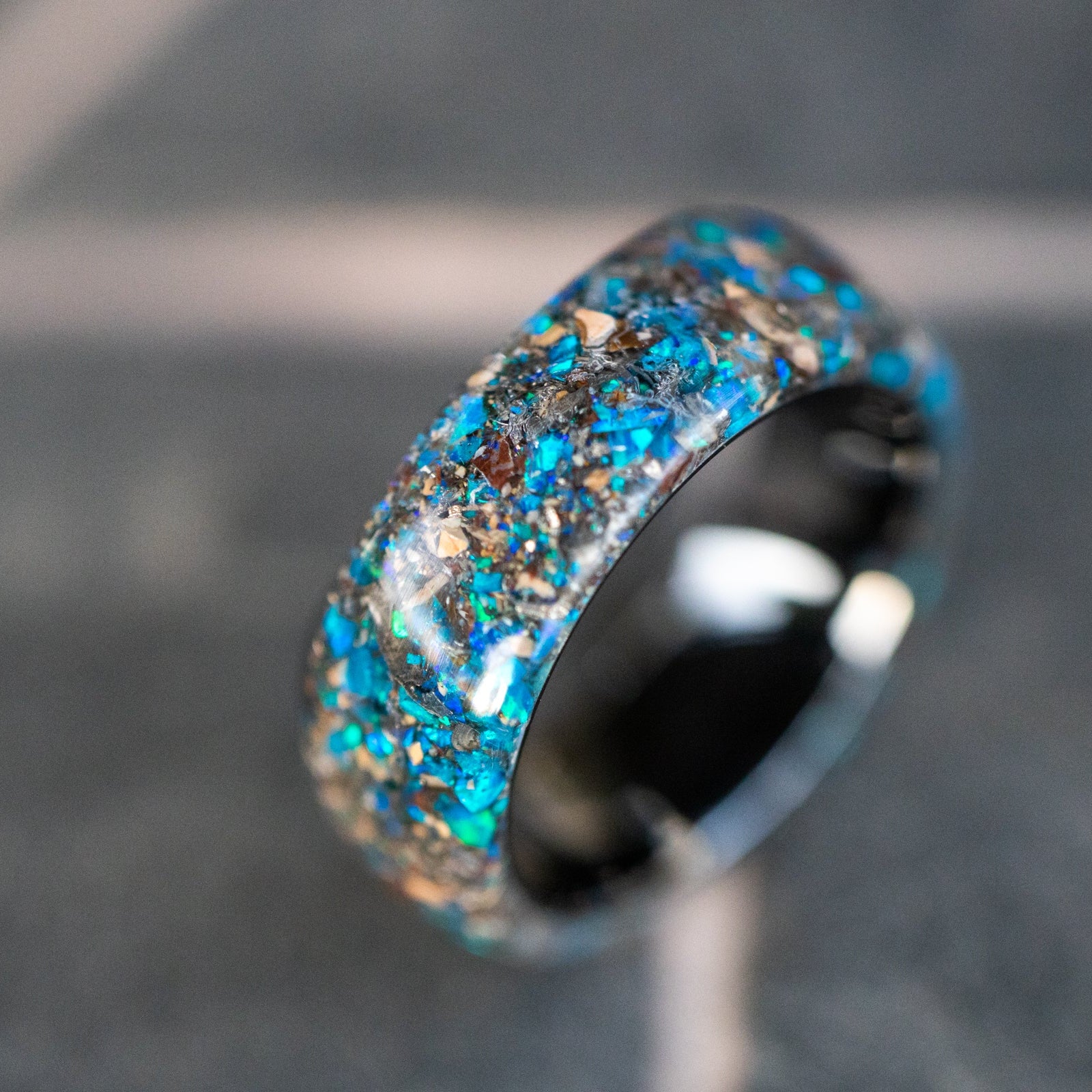 Handcrafted endless black ceramic mens wedding band with authentic Mosasaur bone, Dinosaur Gembone, and Campo del Cielo meteorite in blue opal inlay made in California
