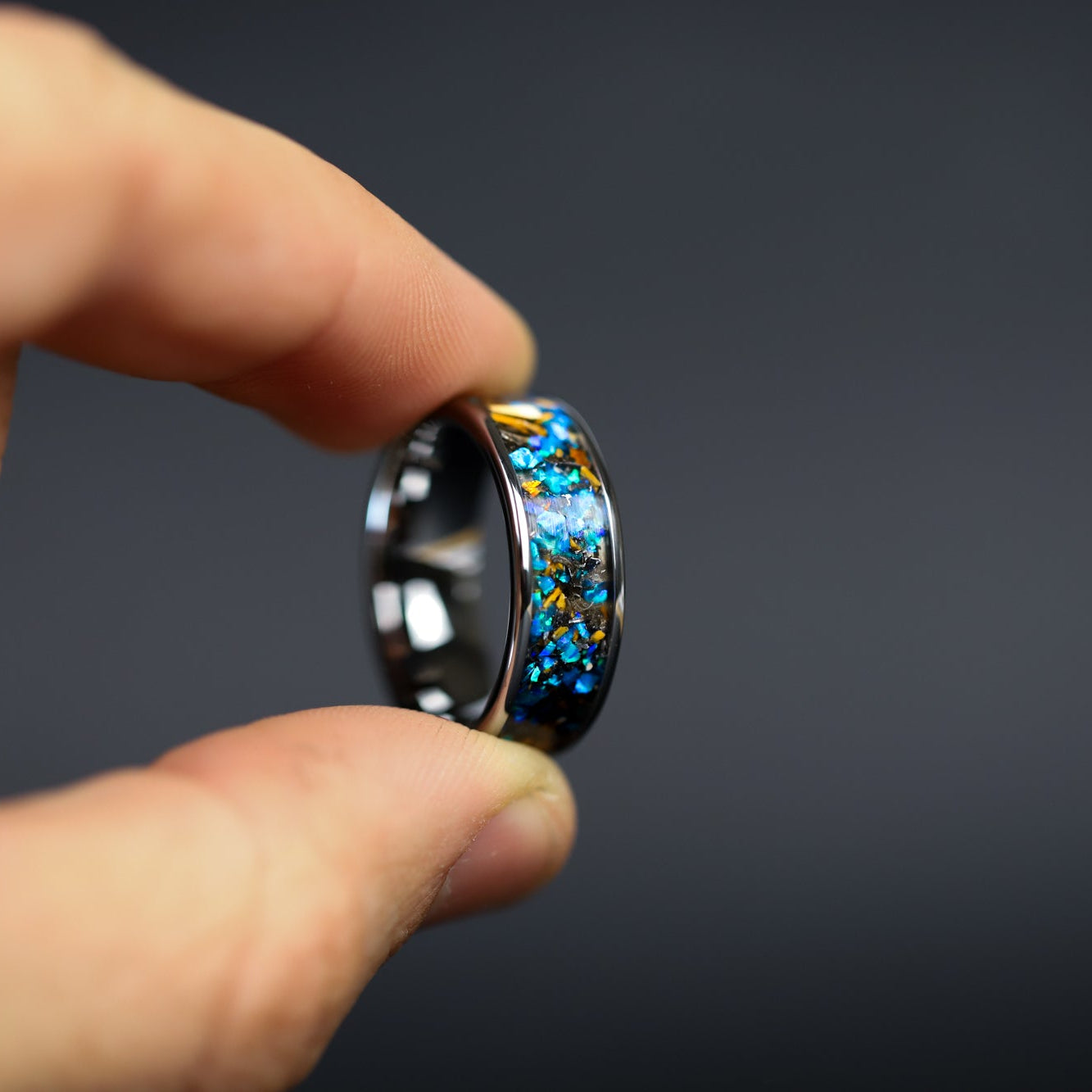 Handcrafted 8mm wide channel tungsten mens wedding band with authentic Velociraptor bone and Campo del Cielo meteorite in blue opal inlay made in California