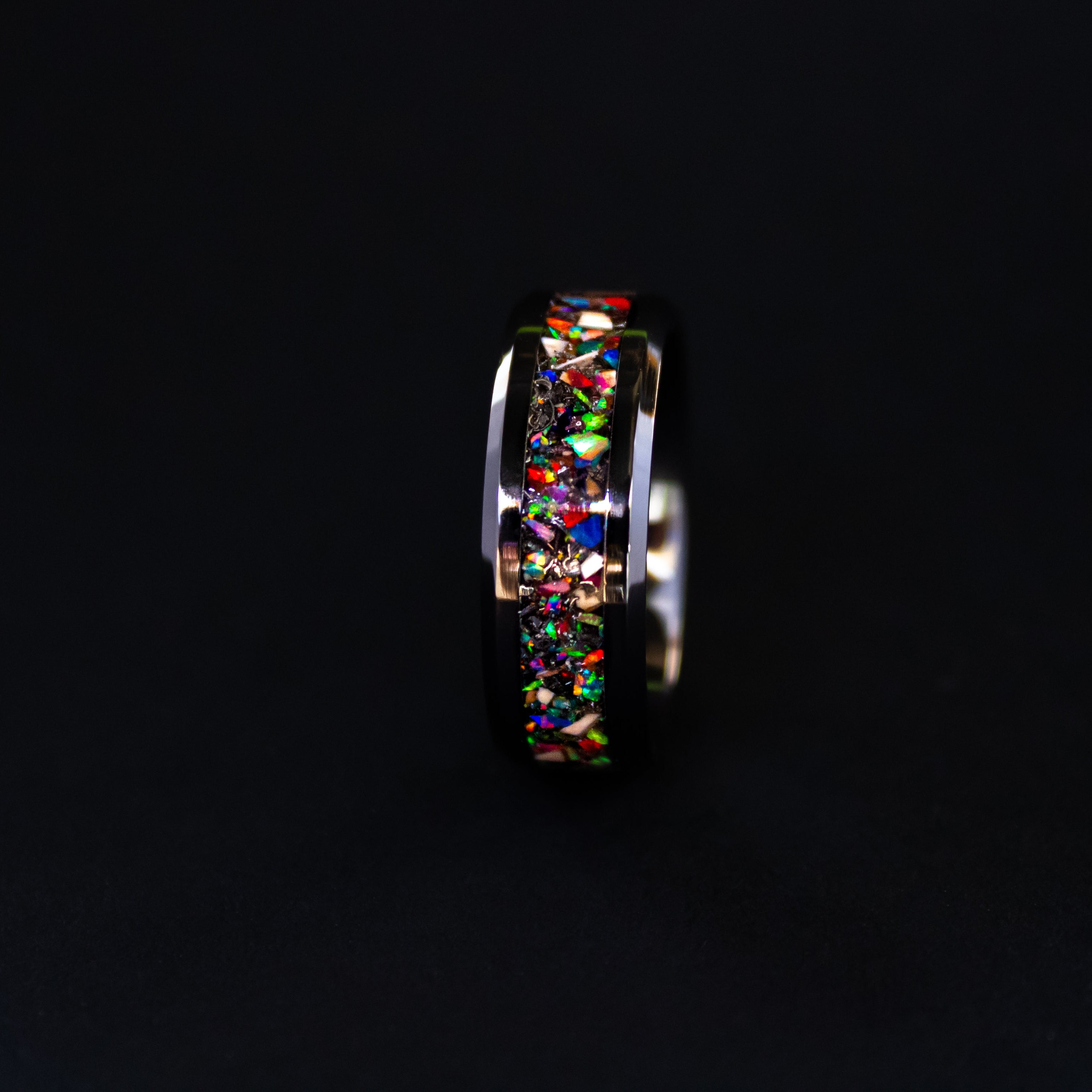 Handcrafted 8mm beveled black ceramic mens wedding band with authentic Mosasaur bone and multi-color opal mosaic inlay made in California