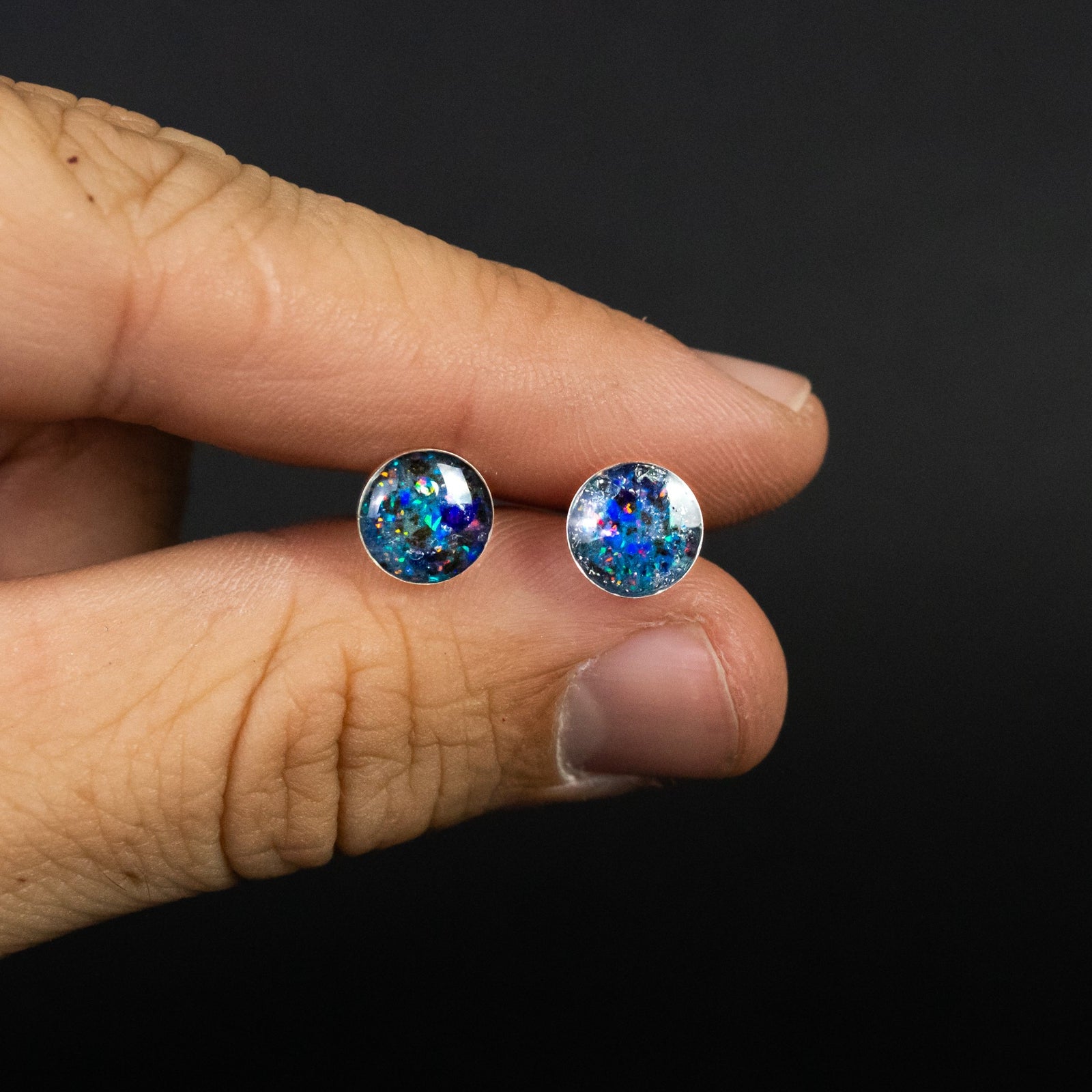 Handcrafted megalodon shark tooth silver stud earrings with Campo Del Cielo meteorite, blue and purple opal, and blue glow in the dark pigment