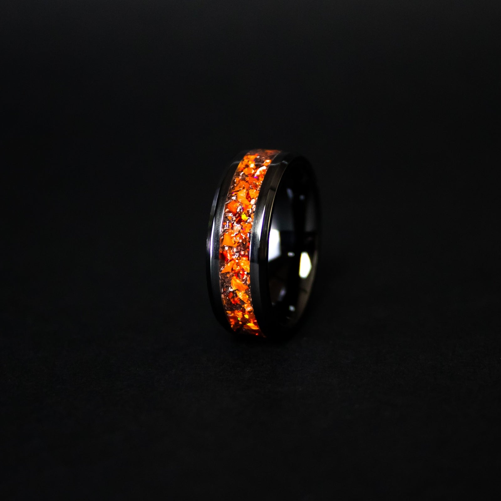 8mm beveled black ceramic ring with authentic Campo del Cielo meteorite shavings suspended in orange opal inlay