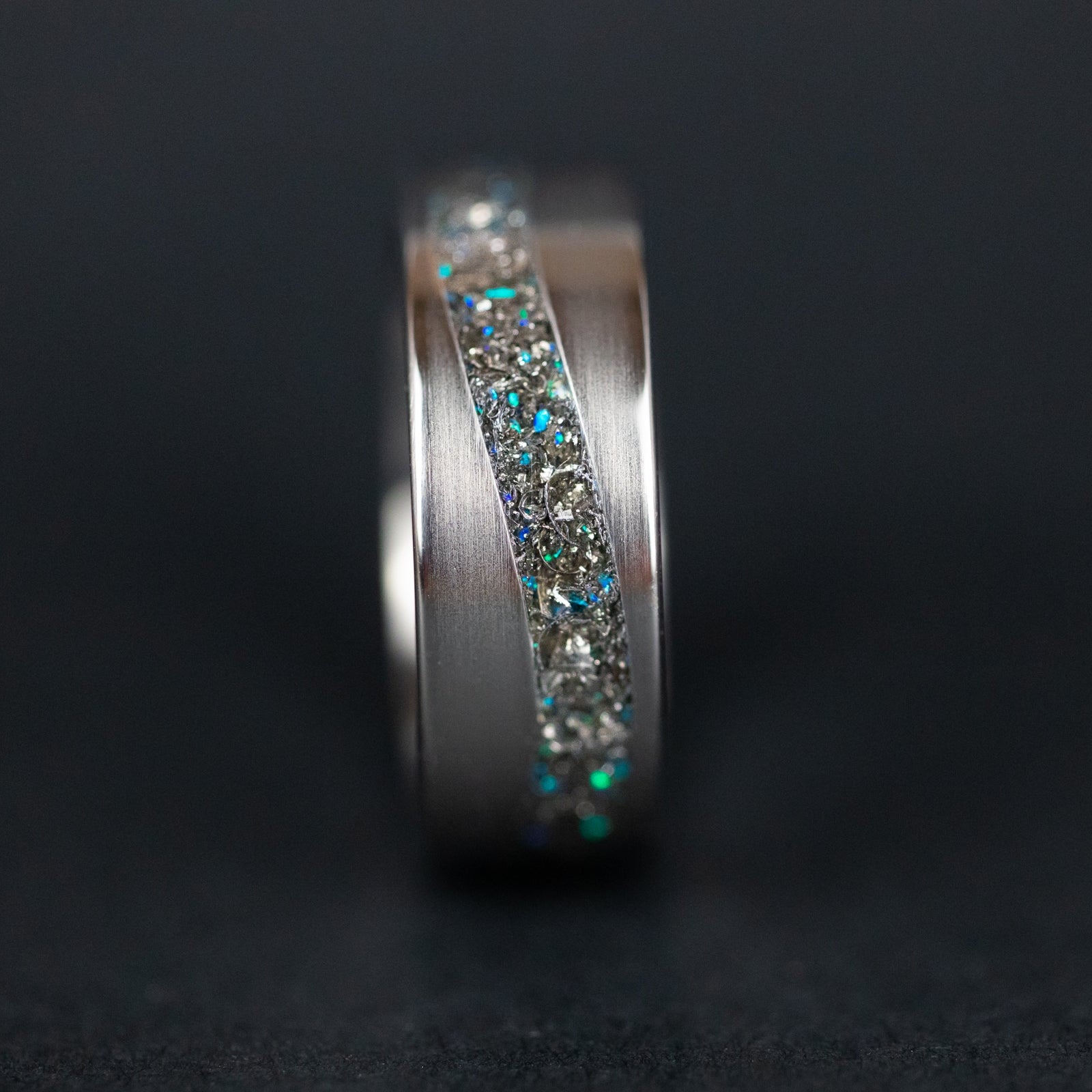 Close-up of the Blue Cosmic Current ring showing Campo Del Cielo meteorite with blue opal accents.