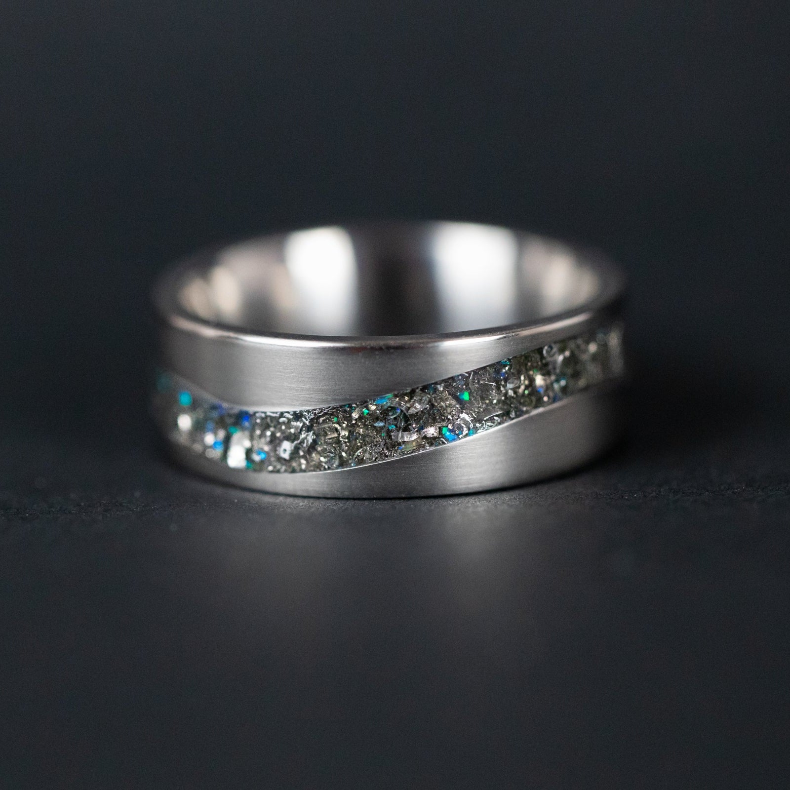 Top view of the Blue Cosmic Current ring showing the flowing curved channel filled with meteorite and blue opal.