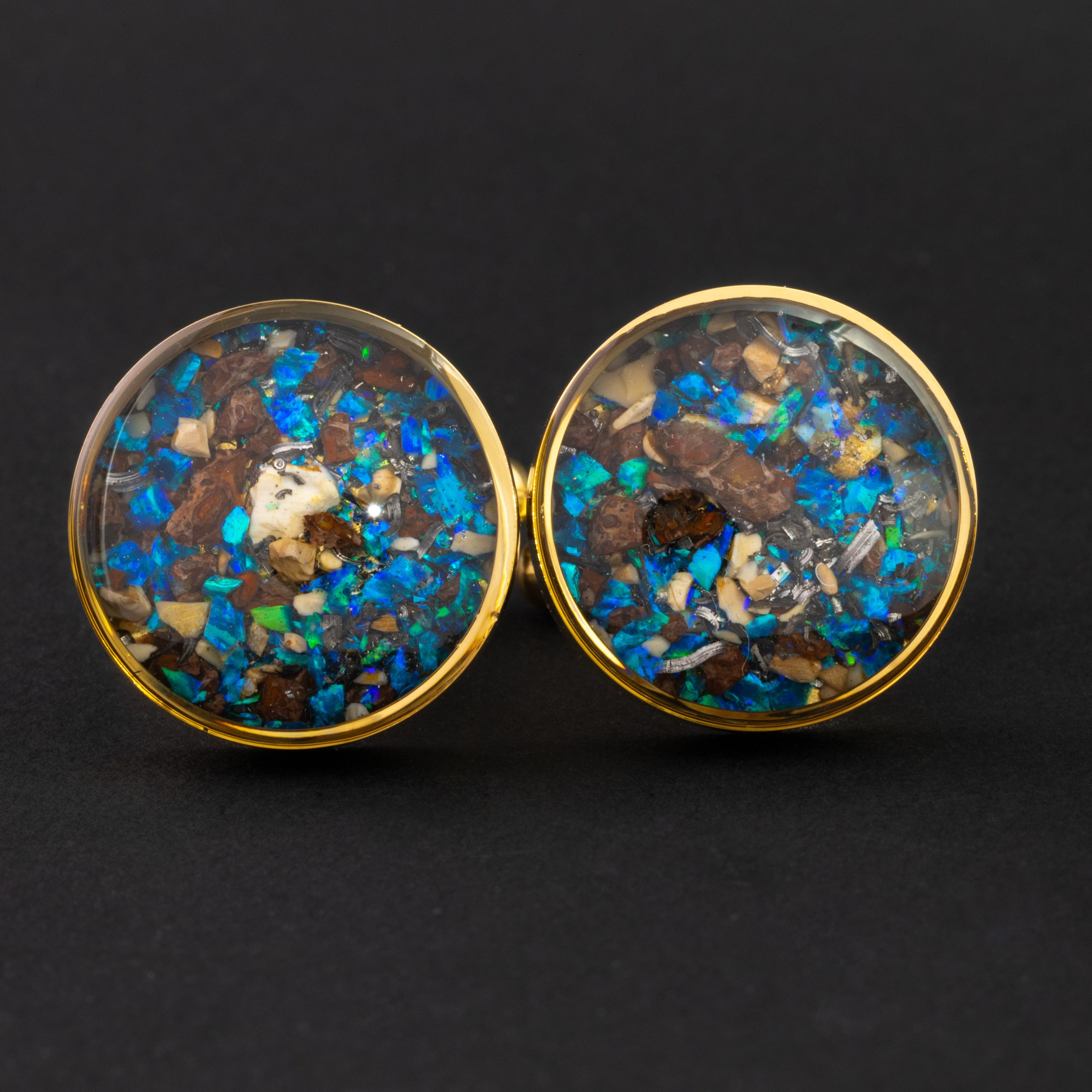 Close-up of the Blue Dinosaur Cufflinks showing Campo Del Cielo iron meteorite, real dinosaur bone, agatized dinosaur gembone, and blue opal set in polished gold-tone stainless steel