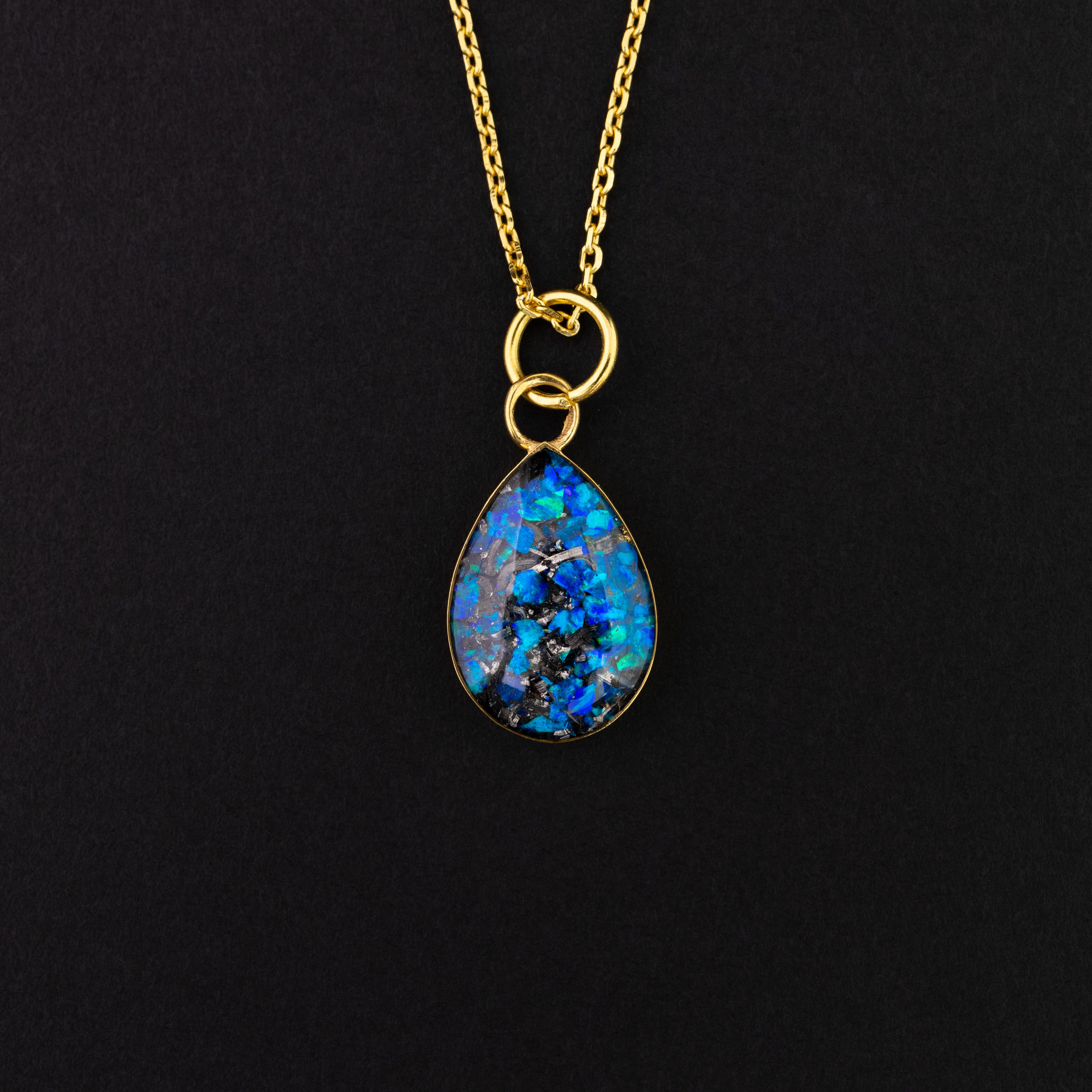 Gold drop shaped necklace with meteorite and blue opals