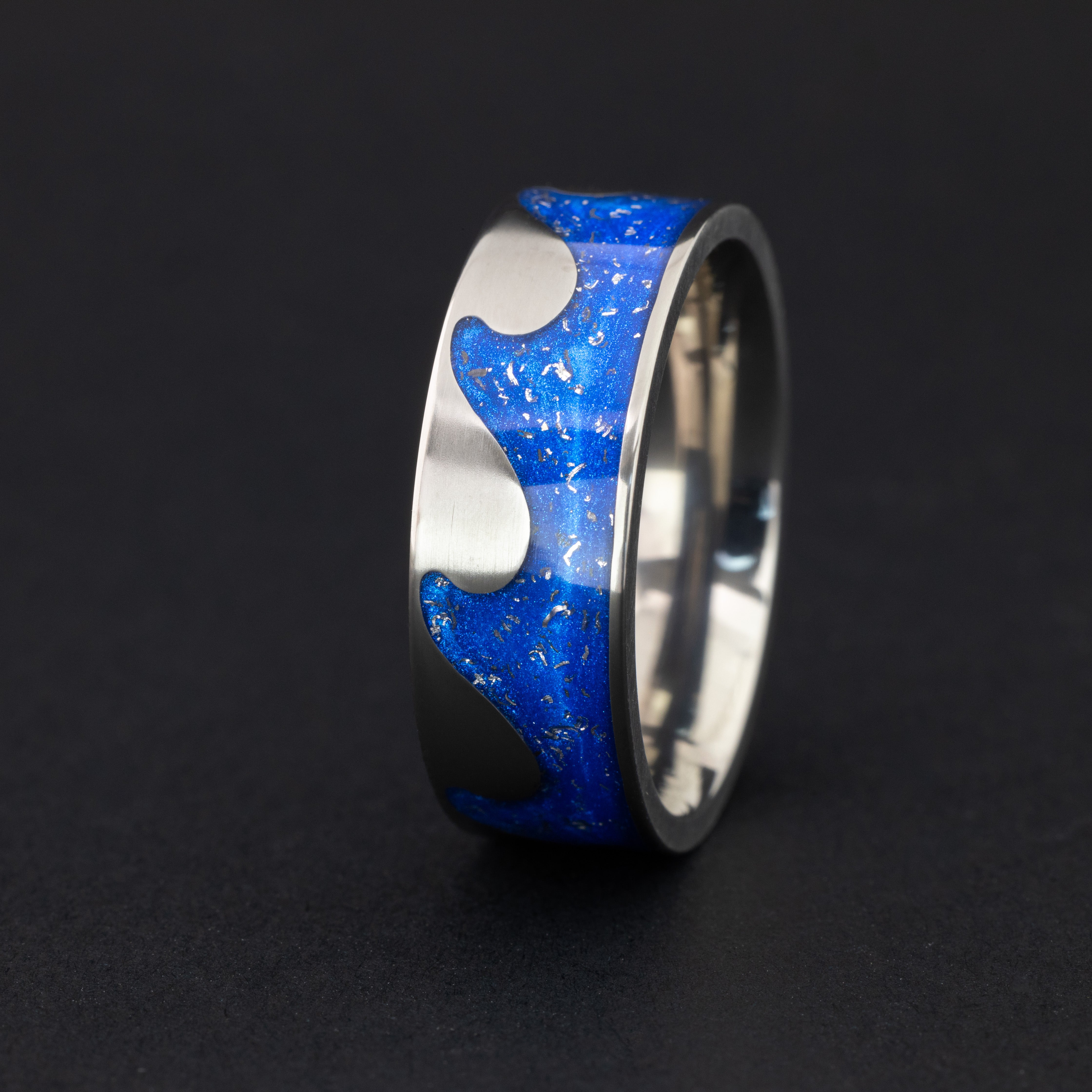 8mm titanium riptide band ring with ocean wave cutout pattern featuring authentic Campo del Cielo meteorite pieces in blue resin