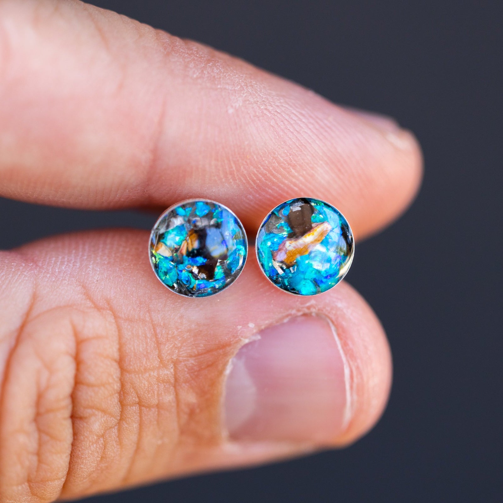 Handcrafted velociraptor fossil silver stud earrings with Campo Del Cielo meteorite, real dinosaur bone, and blue opal inlay