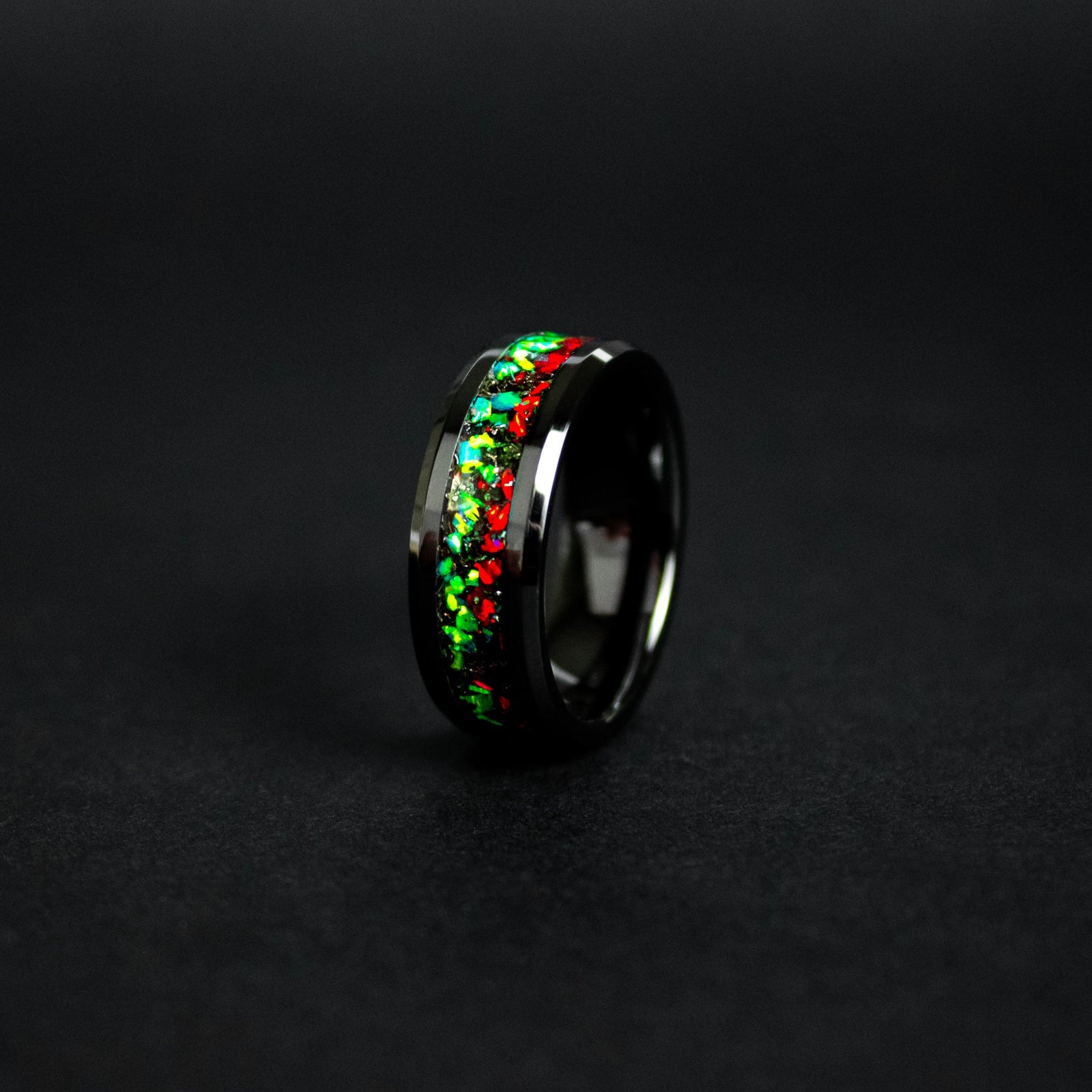 8mm beveled black ceramic ring with authentic Campo del Cielo meteorite shavings in split red and green opal inlay