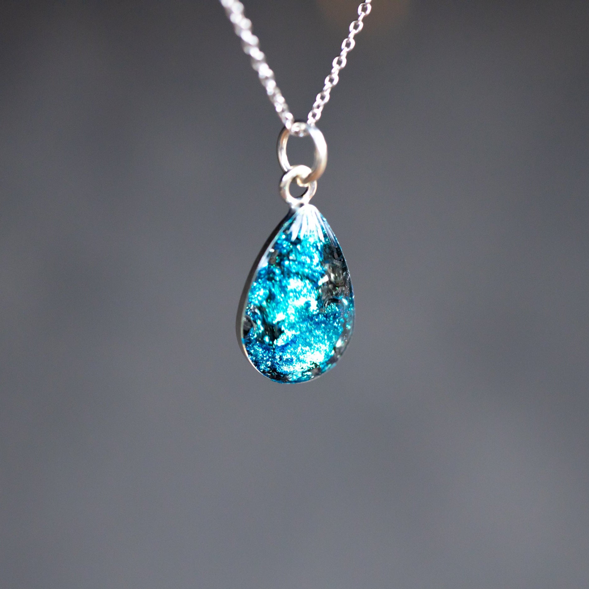 Handcrafted blue meteorite heart pendant necklace in sterling silver with Campo Del Cielo meteorite and deep blue glitter resin inlay