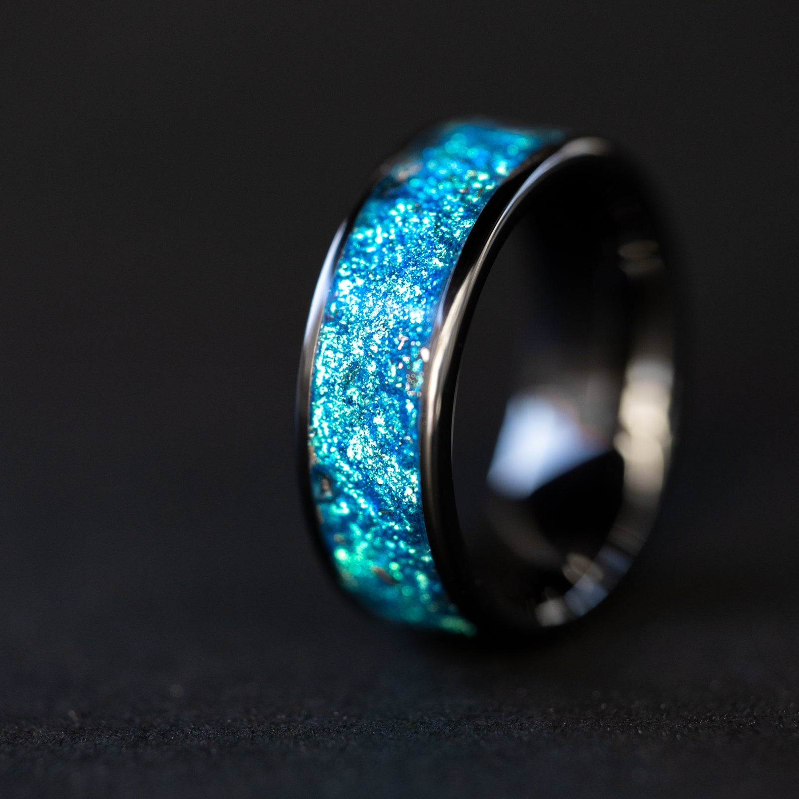 8mm wide channel black ceramic ring with authentic Campo del Cielo meteorite shavings suspended in blue glitter pigment inlay
