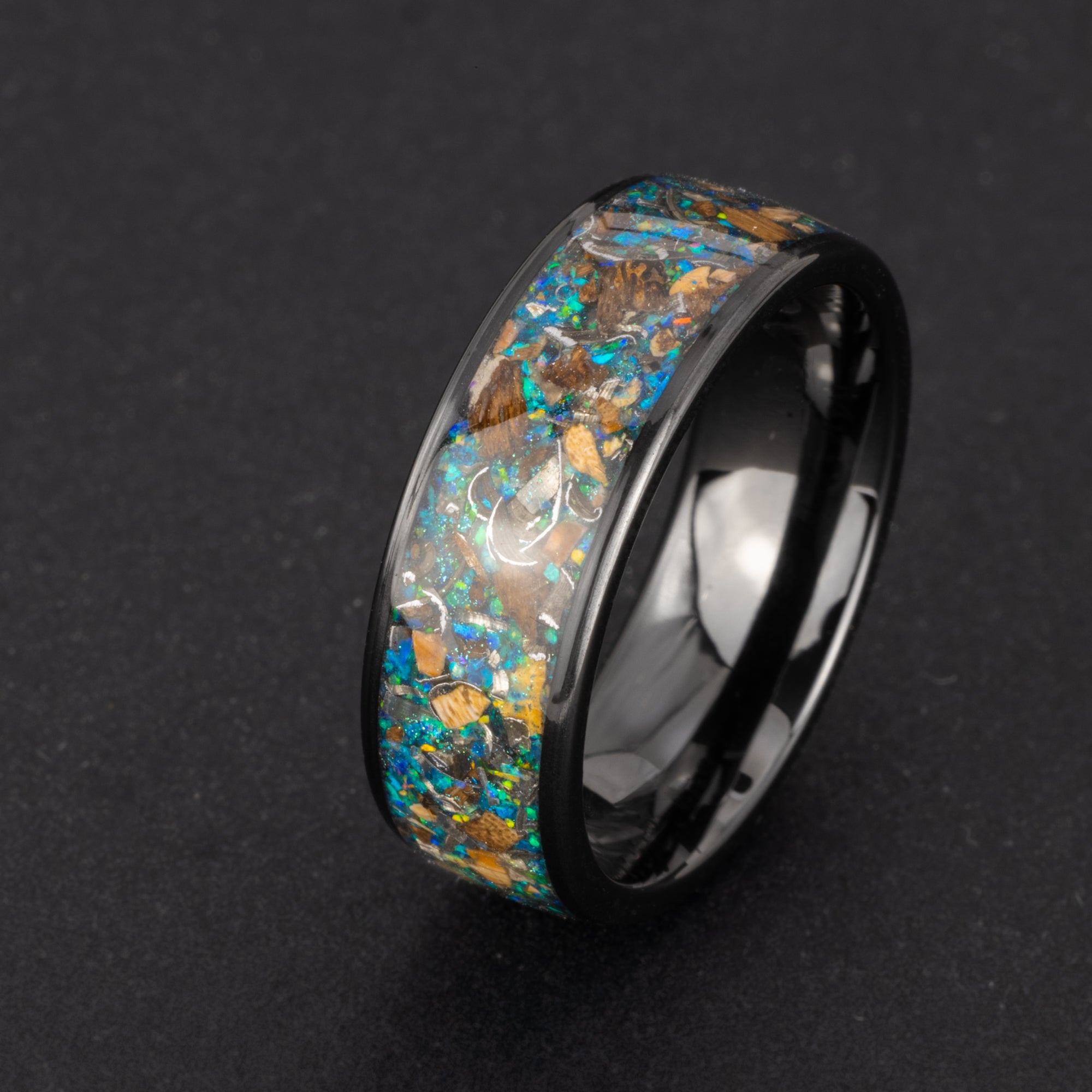 Cosmic Predator Ring 8mm wide channel black ceramic mens wedding band with Campo Del Cielo meteorite, real T-Rex bone, real velociraptor bone, and galaxy opal and glitter inlay