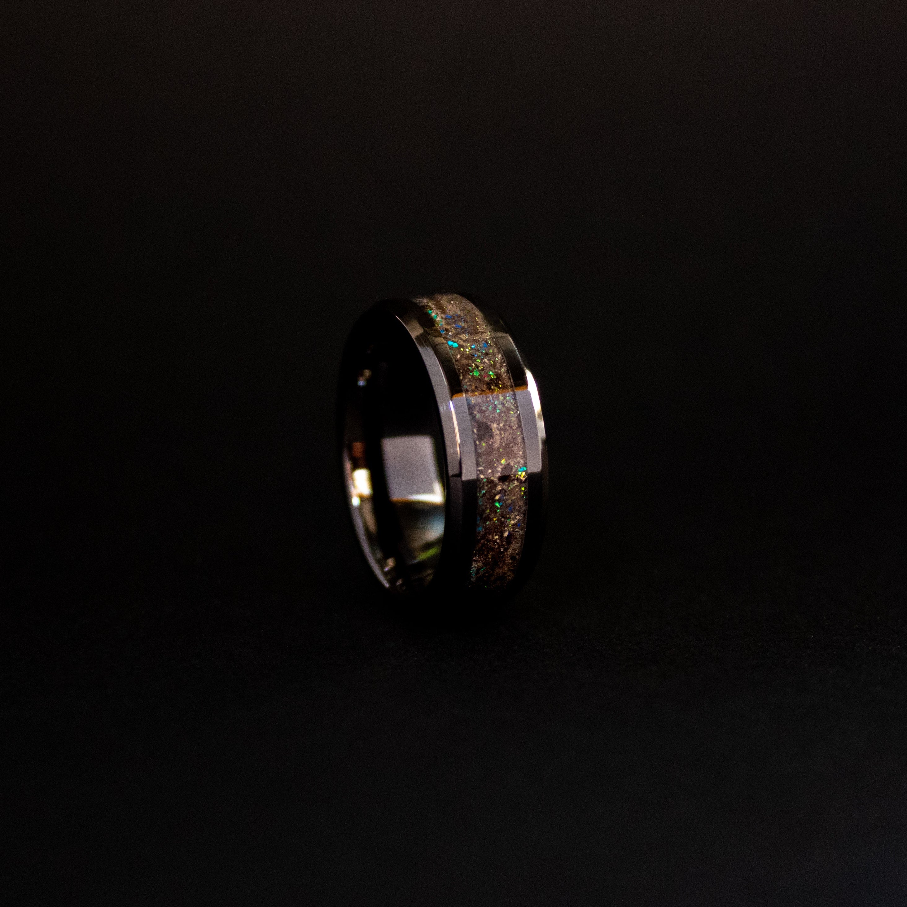 Deep Sea Megalodon Glow ring glowing teal in total darkness showing Megalodon tooth and meteorite suspended in electric teal glow in the dark inlay
