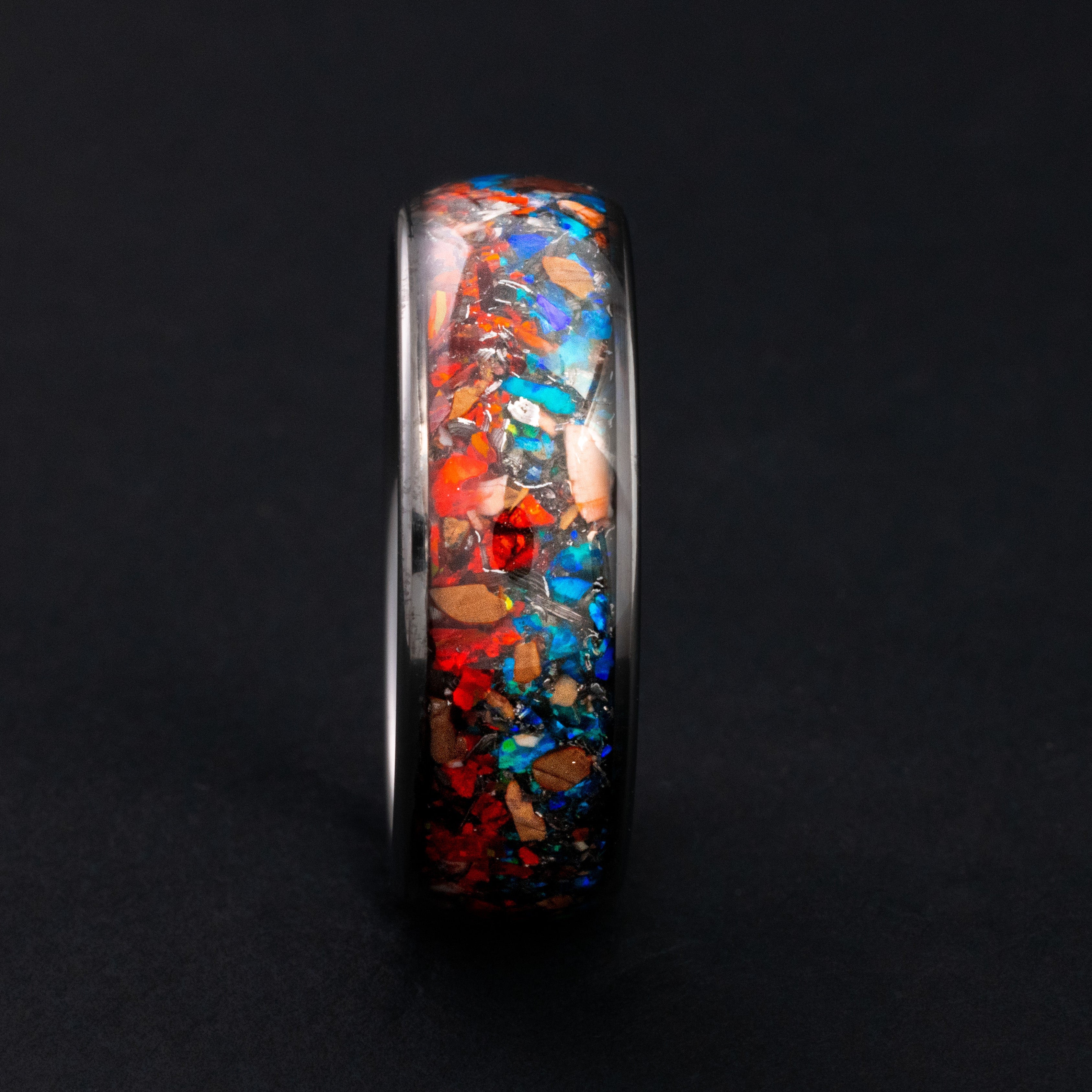 8mm wide channel tungsten ring with Velociraptor bone and red and blue fire opal.