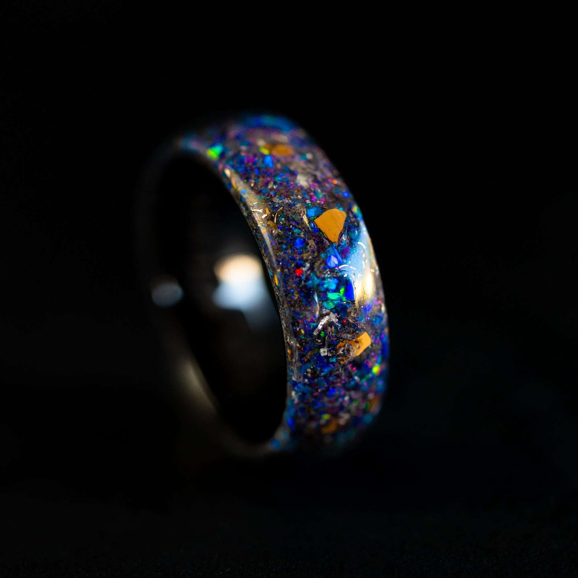 endless black ceramic wedding band featuring prehistoric raptor bone and celestial galaxy shimmer.