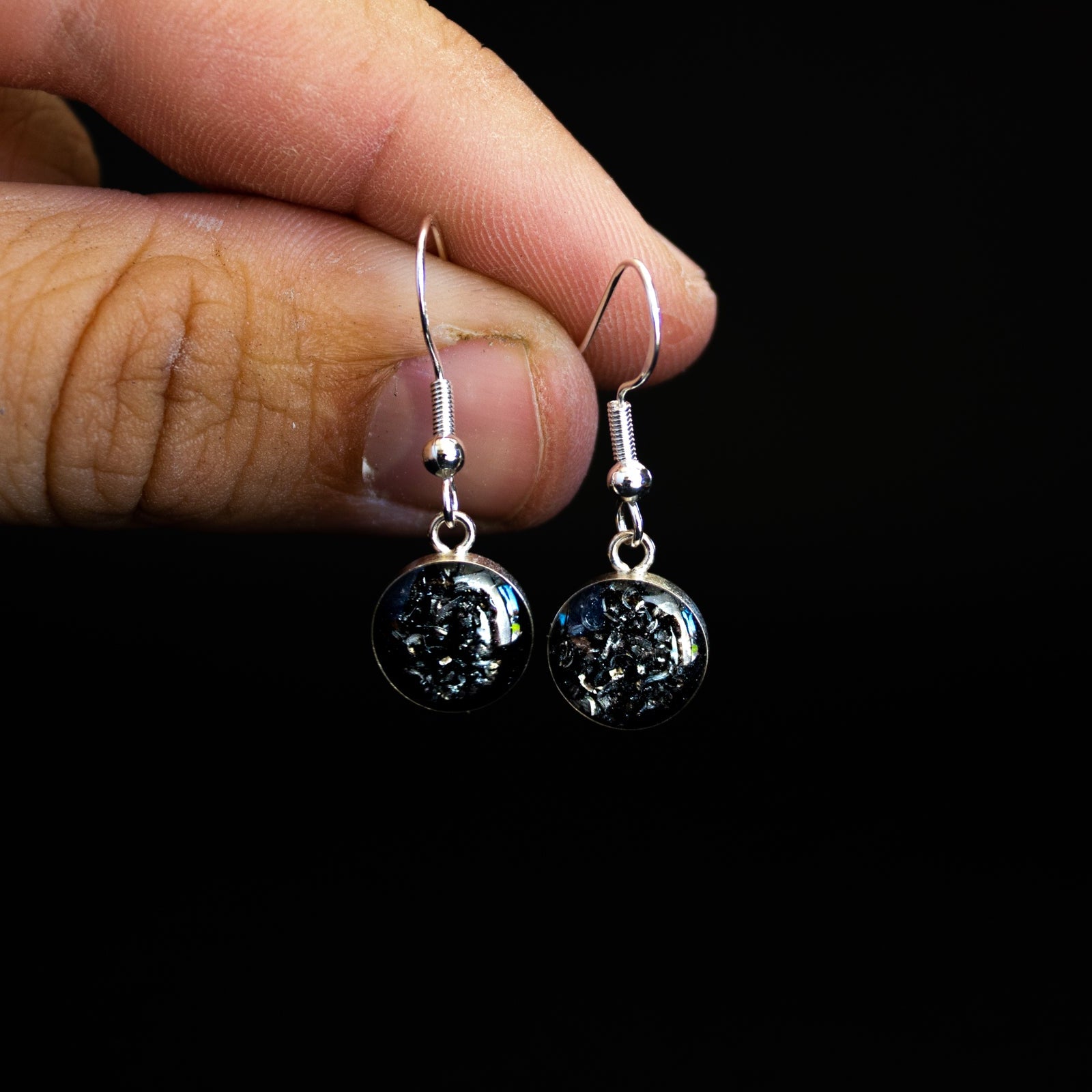 Close-up of the Gibeon Meteorite Dangle showing the natural crystalline pattern of the real iron meteorite in sterling silver