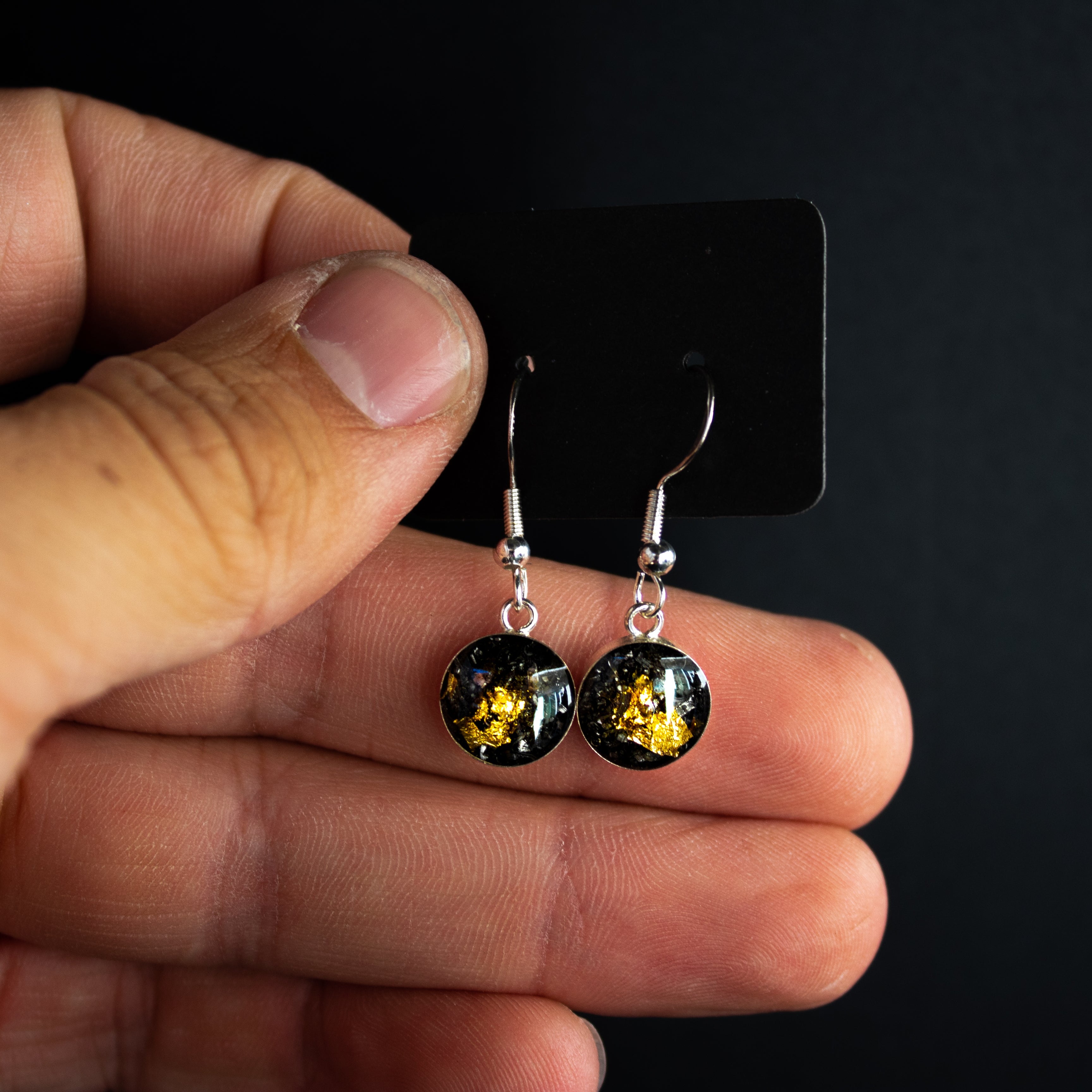 Gold Comet Dangle silver drop earrings with Campo Del Cielo meteorite and gold leaf inlay shown on the ear