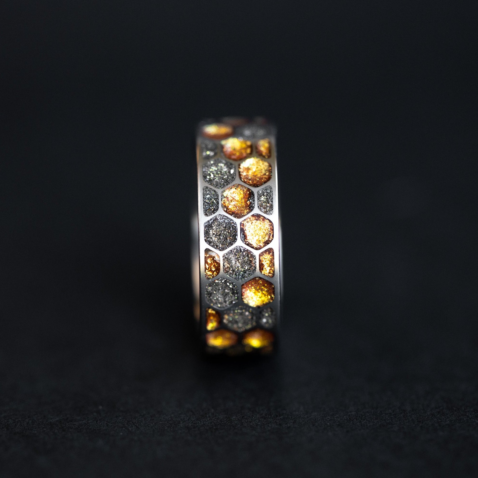 Close-up of the Golden Honeycomb ring showing Campo Del Cielo meteorite fragments in molten gold resin cells.