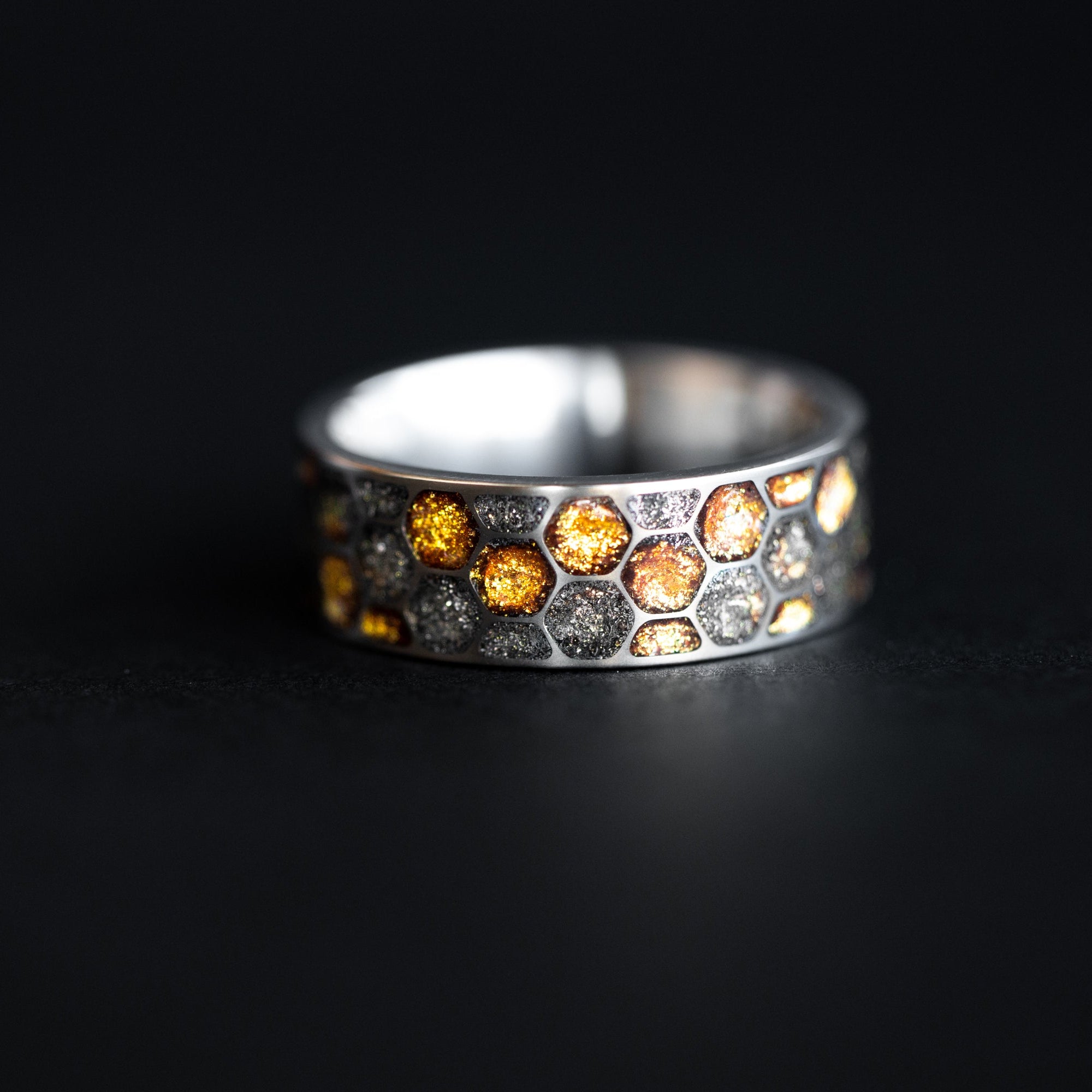 Side profile of the handcrafted titanium Golden Honeycomb ring made in a California studio.