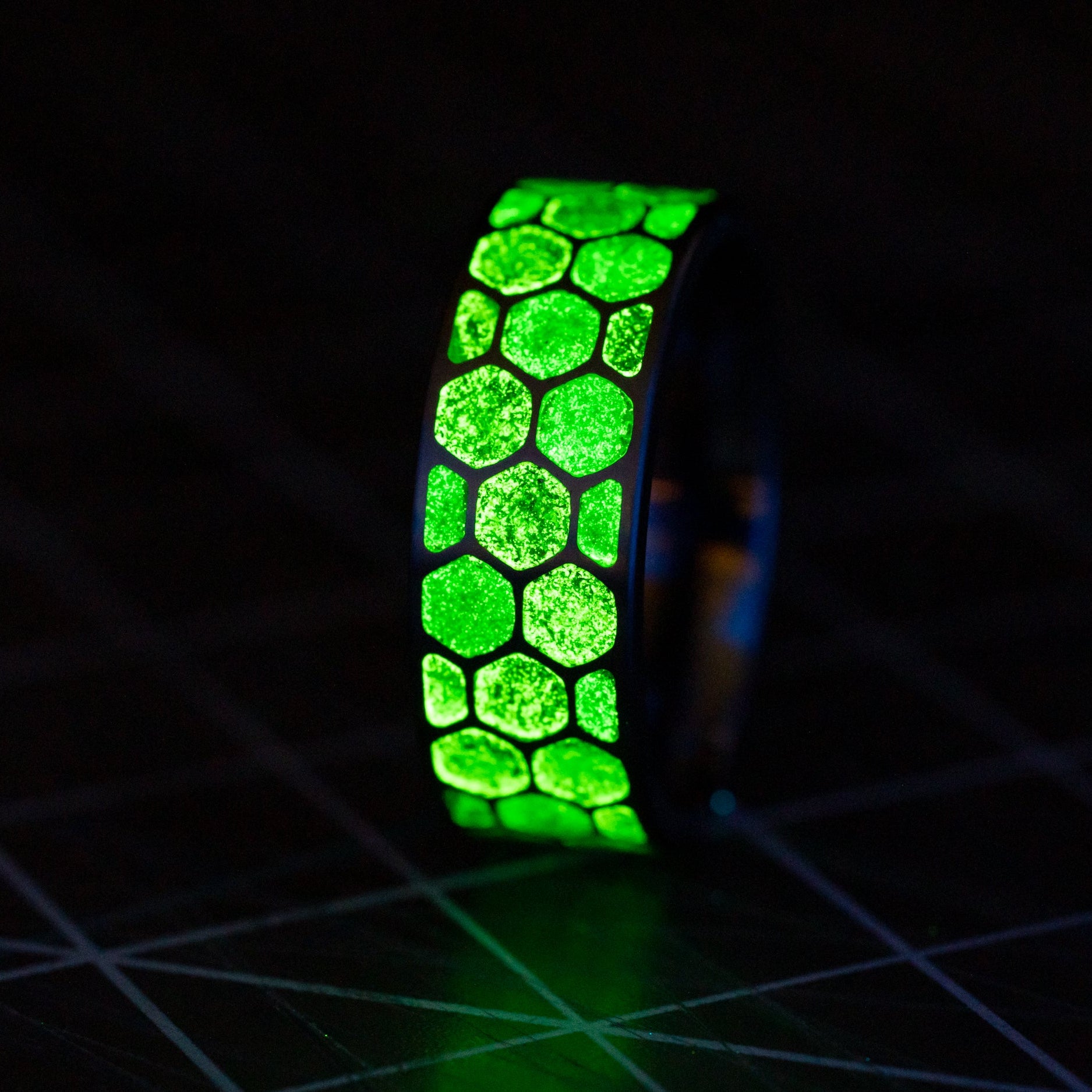 Close-up of the Green Hive Glow ring showing Campo Del Cielo meteorite fragments in deep green resin cells.