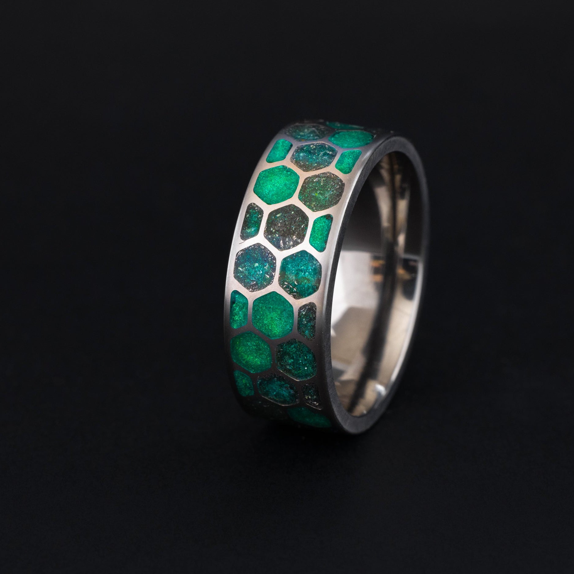 Titanium Green Hive Glow ring with green resin and meteorite inlay in a honeycomb pattern.