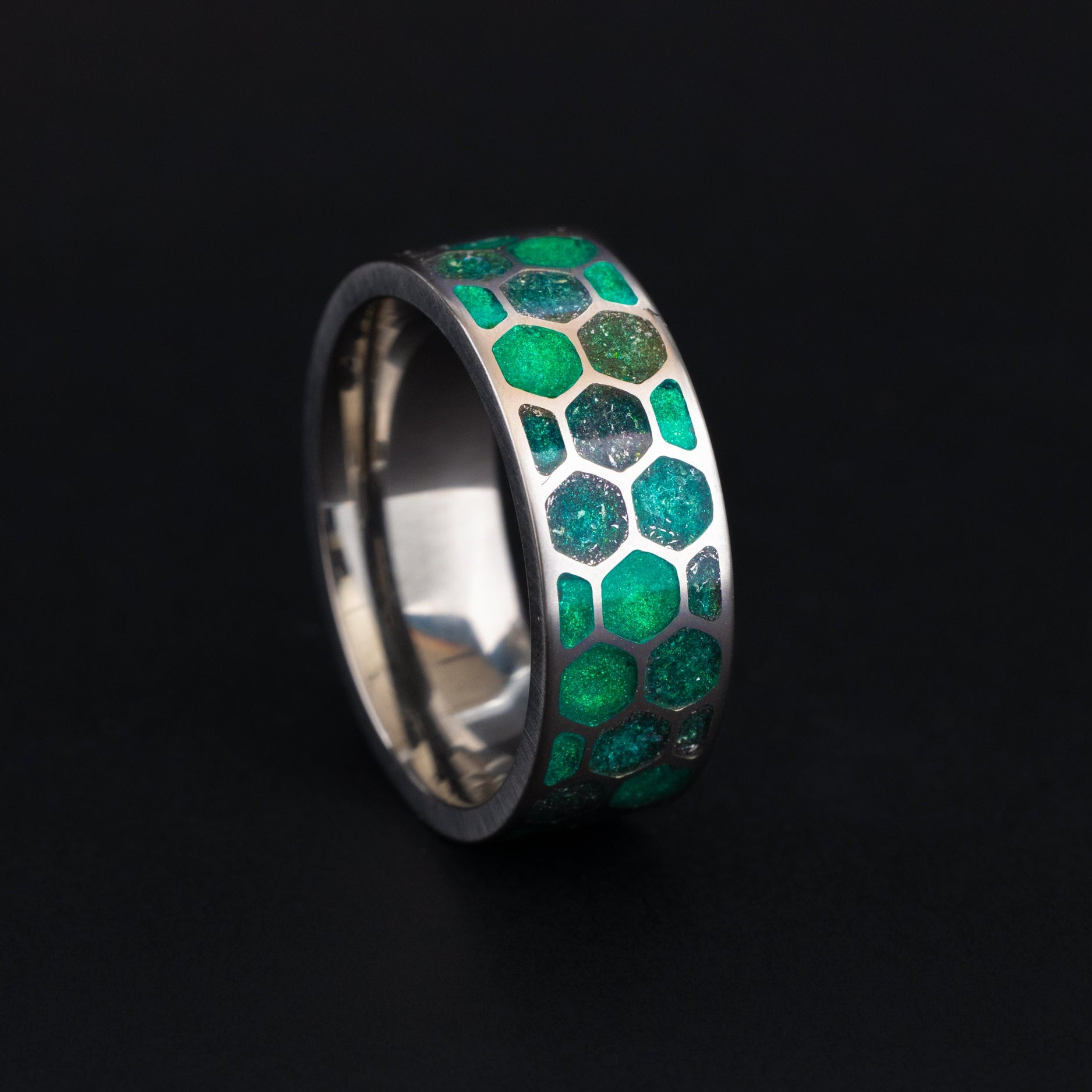 handcrafted titanium Green Hive Glow ring with honeycomb cells made in a California studio.