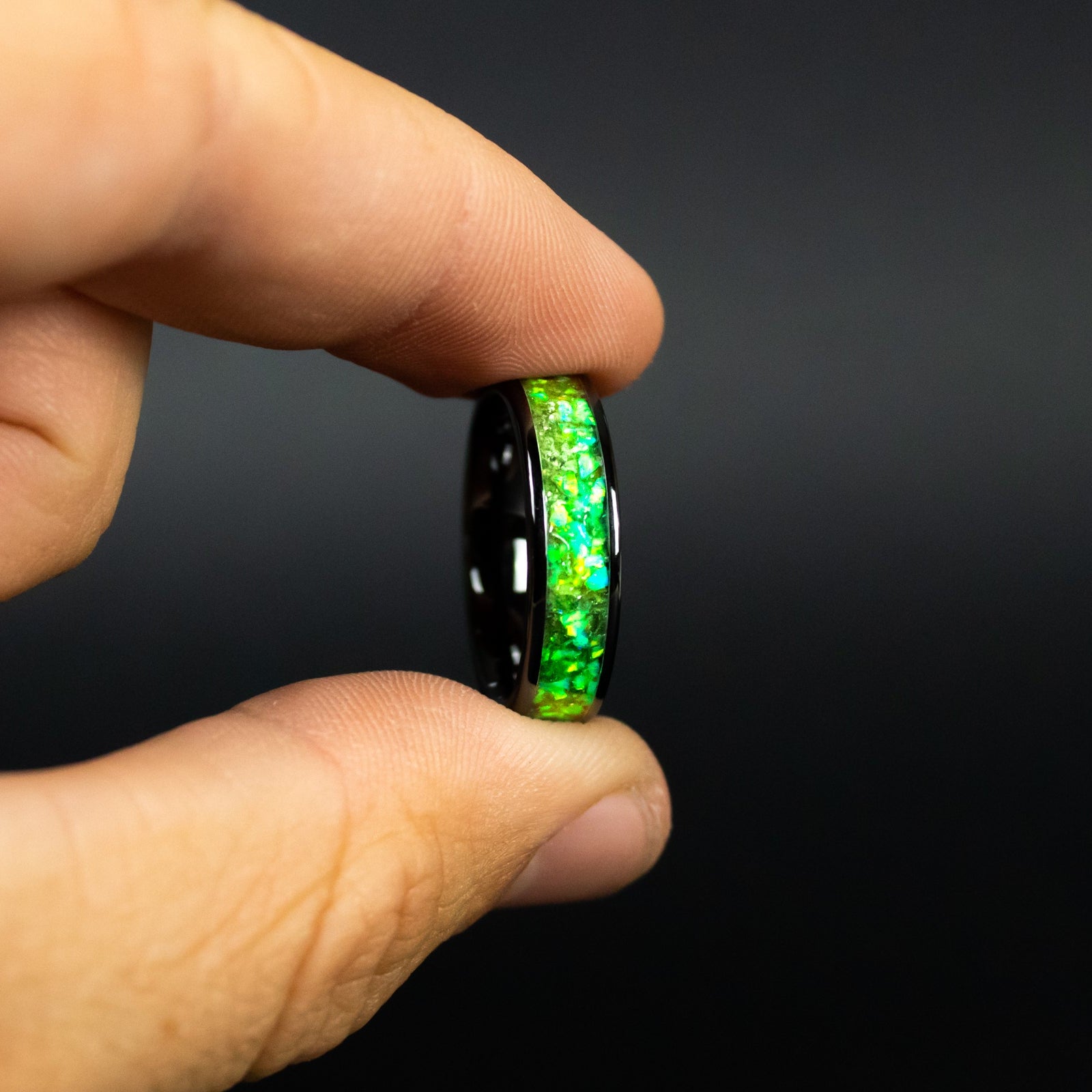 Green Orbit Glow ring glowing green in total darkness showing Campo del Cielo meteorite shavings suspended in electric green glow in the dark inlay
