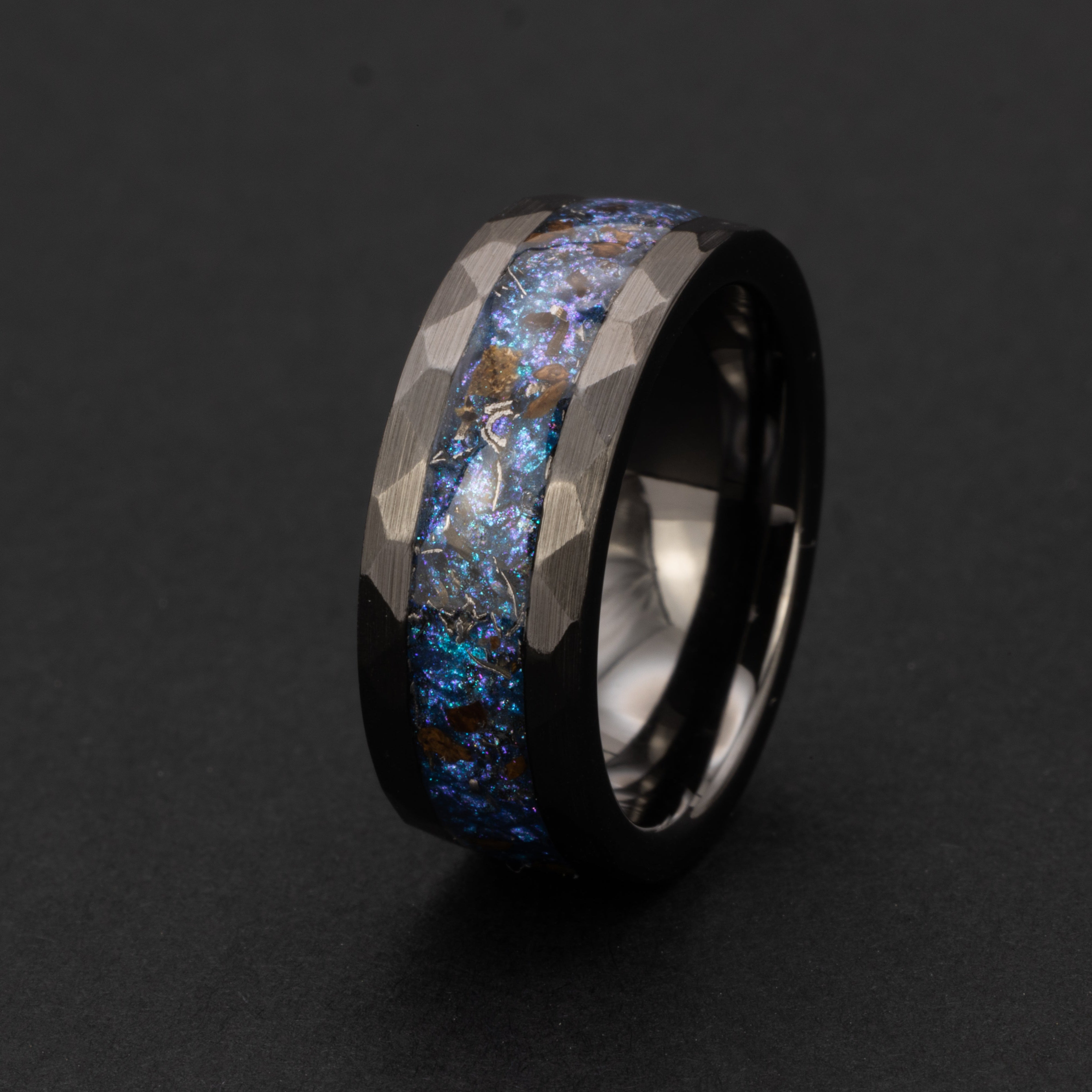Hammered black ceramic ring with authentic T-Rex bone and Campo del Cielo meteorite in blue and purple opal galaxy inlay