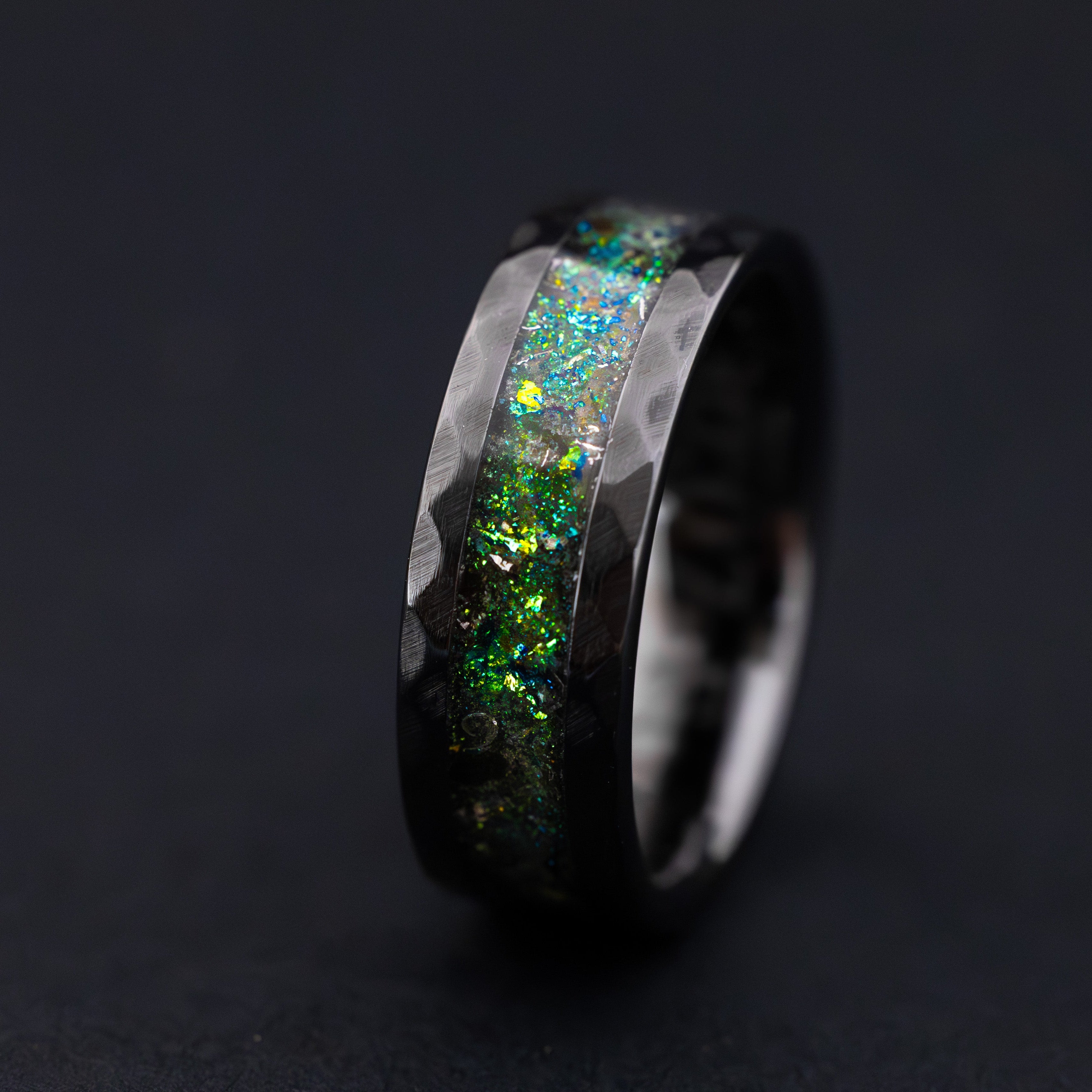 8mm hammered black ceramic ring with Megalodon tooth fossil, Campo meteorite, and teal glow inlay.