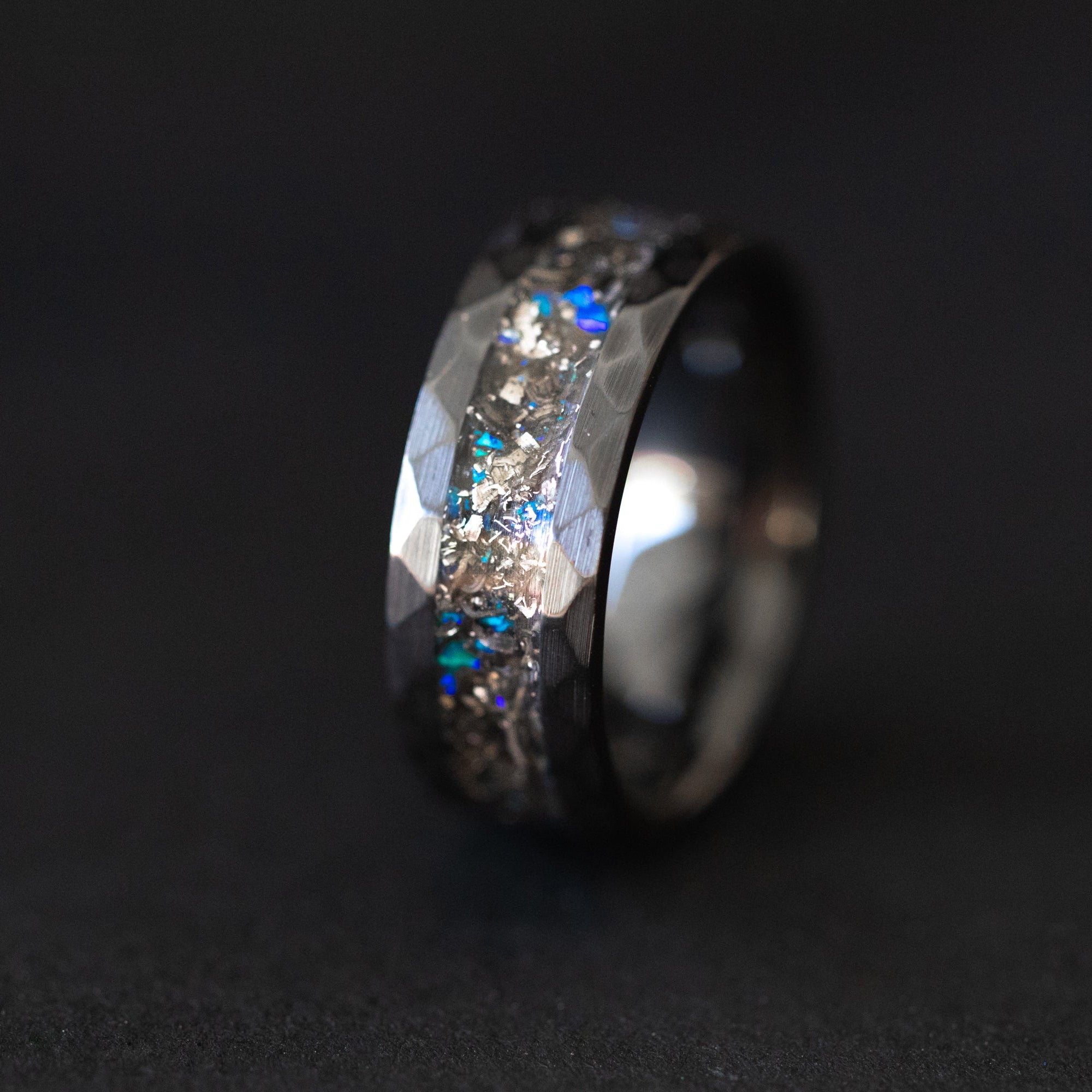 Hammered black ceramic ring with authentic Campo del Cielo meteorite shavings and blue opal accent inlay