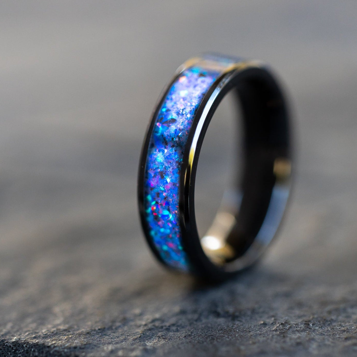 6mm wide channel ceramic ring with authentic Megalodon tooth fossil and Campo del Cielo meteorite in midnight opal inlay glowing blue in the dark