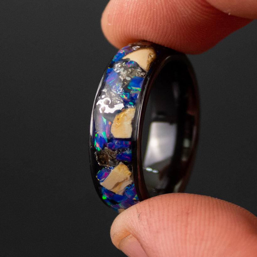 8mm wide channel black ceramic ring with large pieces of authentic Mosasaur bone and Campo del Cielo meteorite in midnight blue purple opal inlay