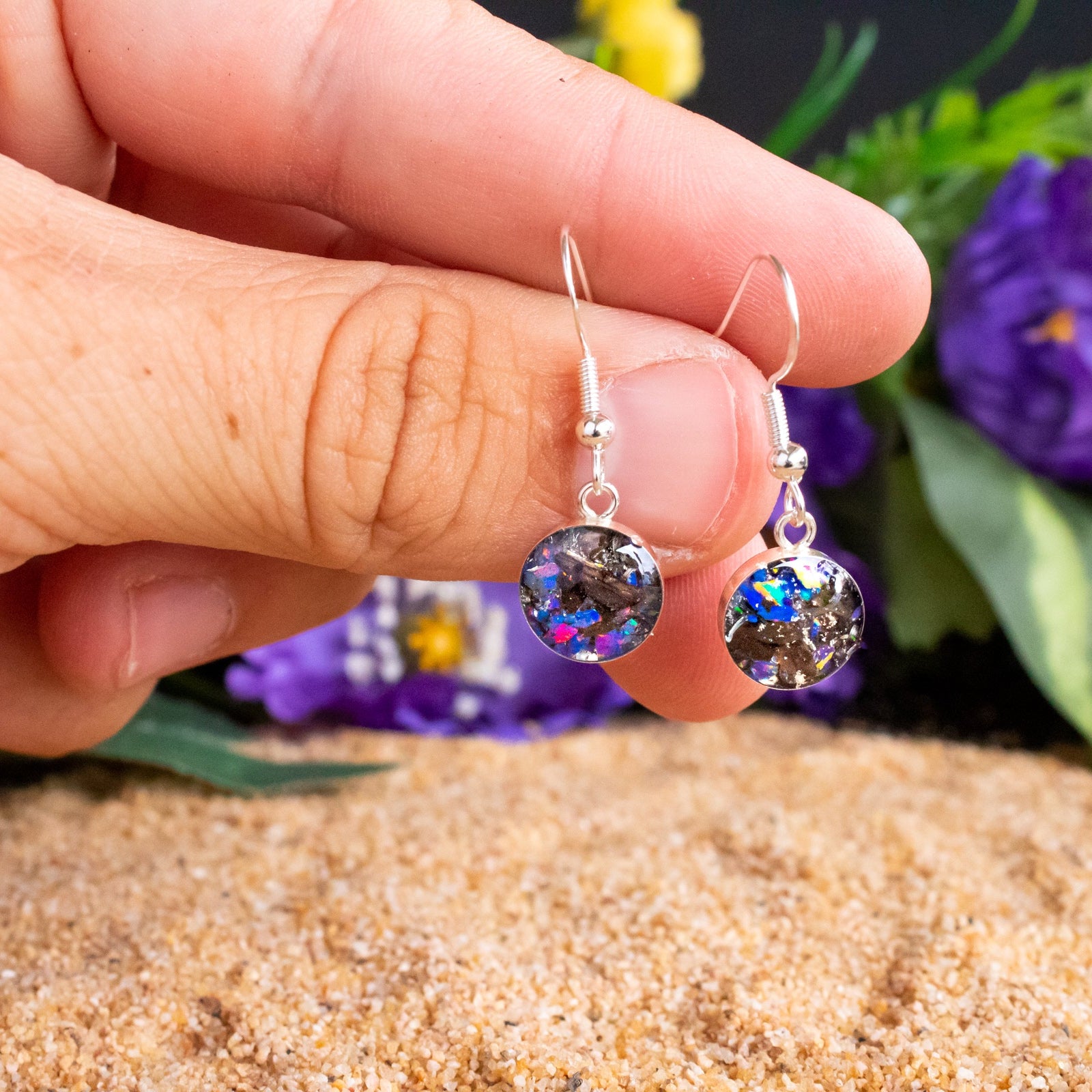 Close-up of the Midnight TRex Dangle showing Campo Del Cielo iron meteorite, real T-Rex bone, and proprietary purple blue Midnight Opal in each earring