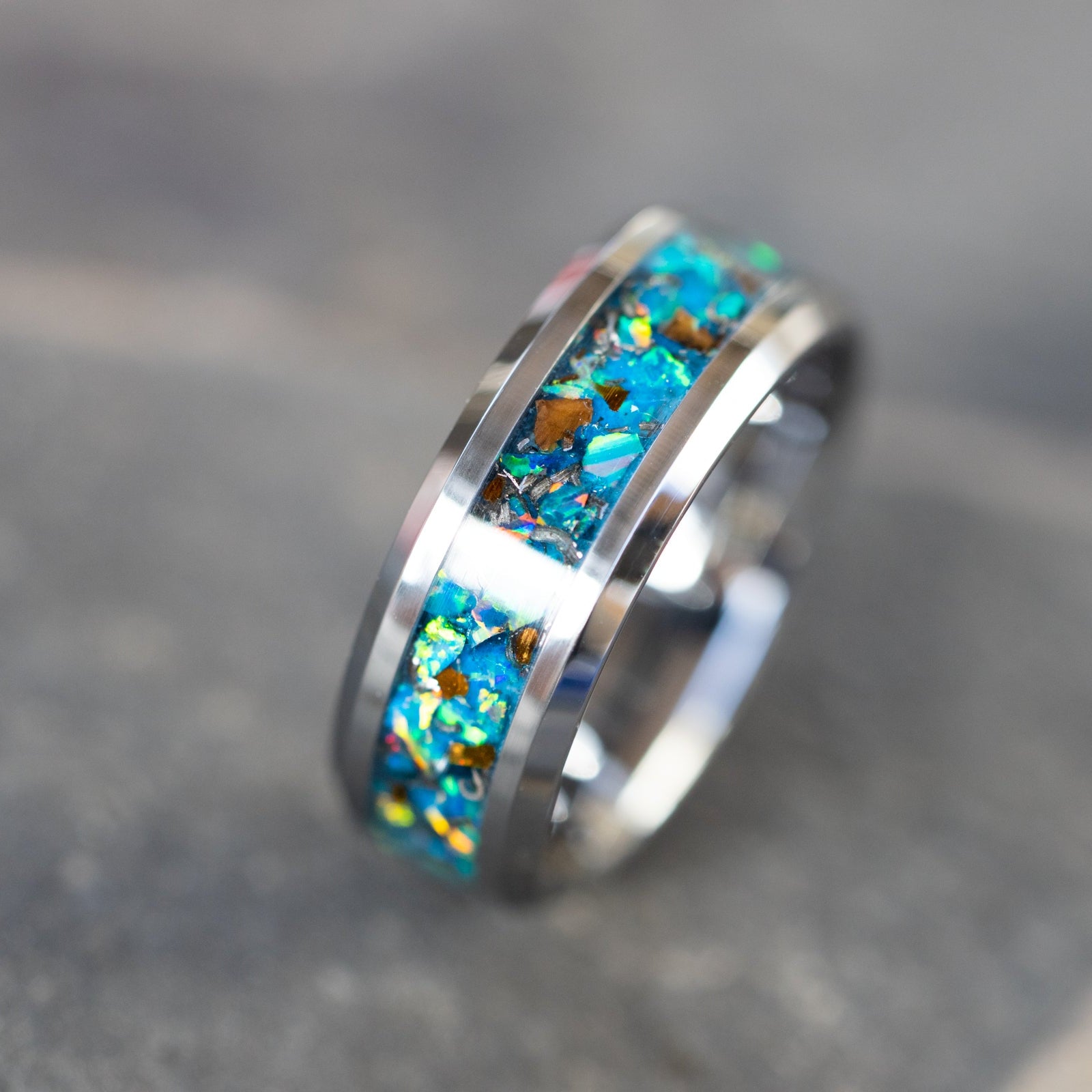 8mm beveled tungsten ring with authentic T-Rex bone and Campo del Cielo meteorite in light blue teal oasis opal inlay glowing blue in the dark