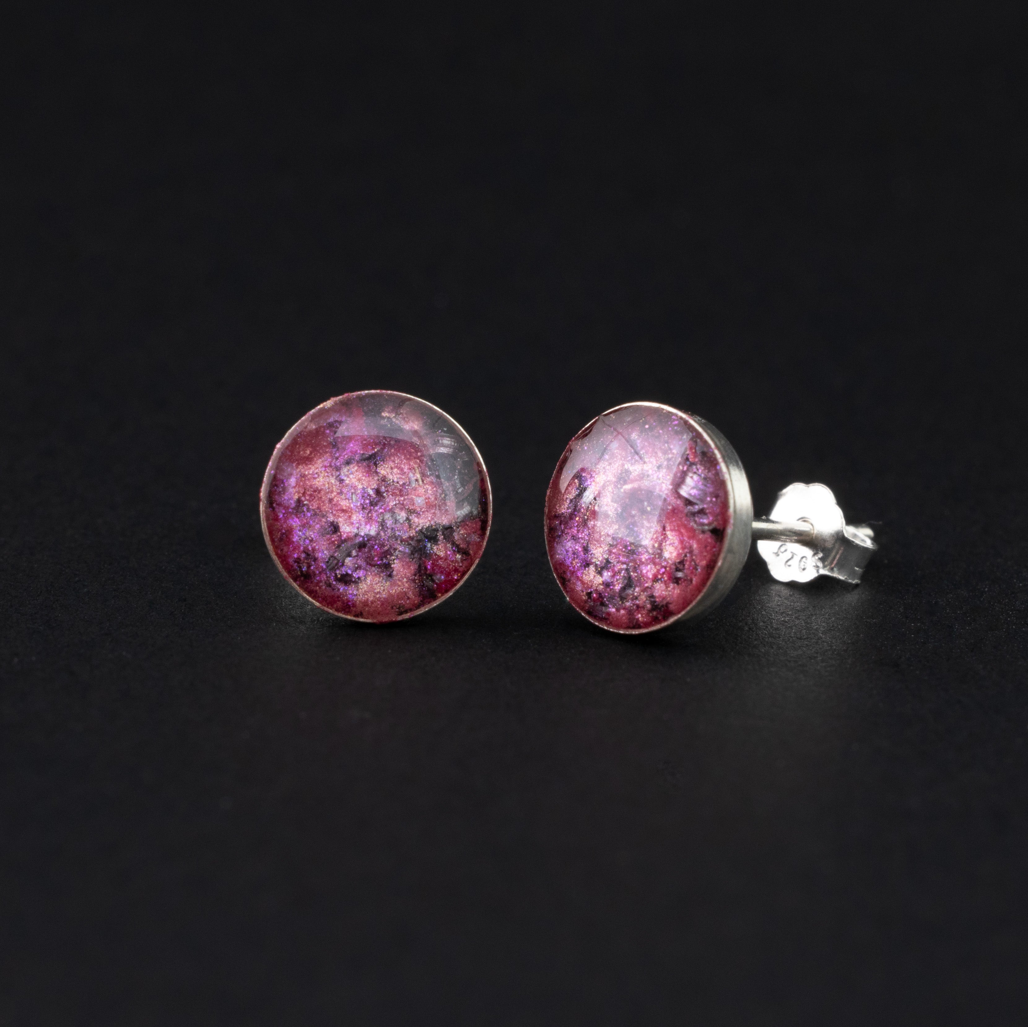 Close-up of the Pink Comet Studs pink stud earrings showing Campo Del Cielo iron meteorite set in vivid pink glitter in sterling silver