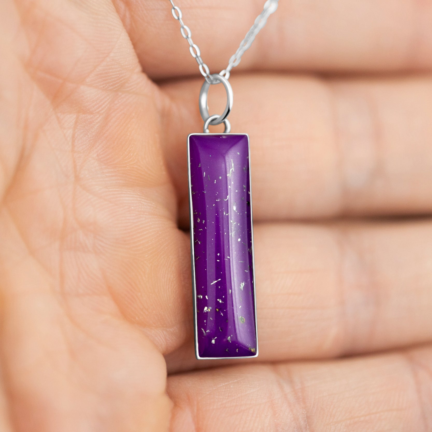 Handcrafted sterling silver bar pendant necklace with meteorite and purple resin inlay shown from the front