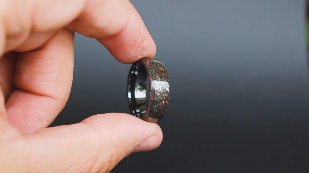 360 degree product view of the Crimson Iron ring showing Campo del Cielo meteorite shavings and red opal accents on endless black ceramic band