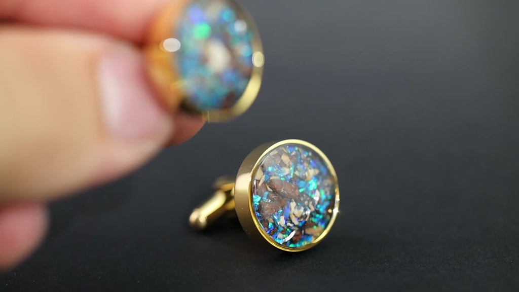 Video of the Blue Dinosaur Cufflinks handcrafted gold-tone stainless steel mens cufflinks featuring authentic Campo Del Cielo meteorite, real dinosaur bone, crushed dinosaur gembone, and vivid blue opal inlay