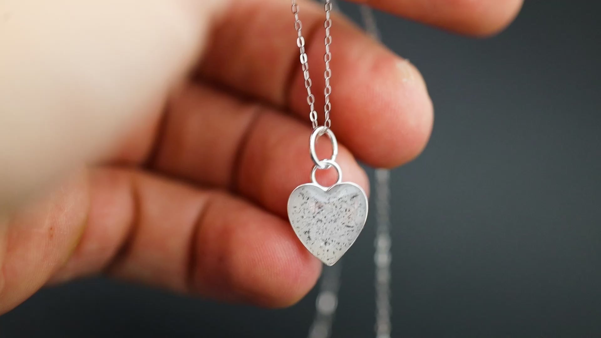 Video of the Polar Pulse handcrafted white heart necklace in sterling silver featuring authentic Campo Del Cielo meteorite and clean white resin inlay