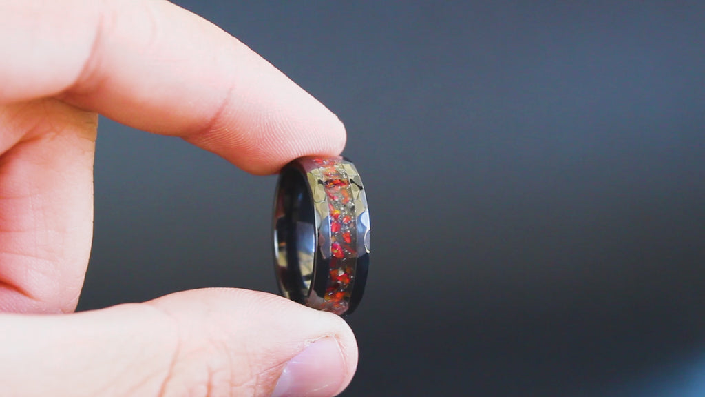 360 degree product view of the Hammered Rex ring showing T-Rex bone and Campo del Cielo meteorite shifting through red opal inlay on hammered black ceramic band