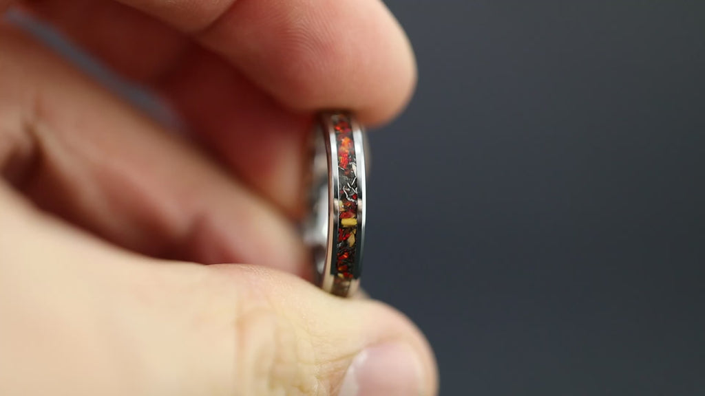 Cinematic view of the Thin Red Raptor ring showing the red opal glow and 4mm profile.
