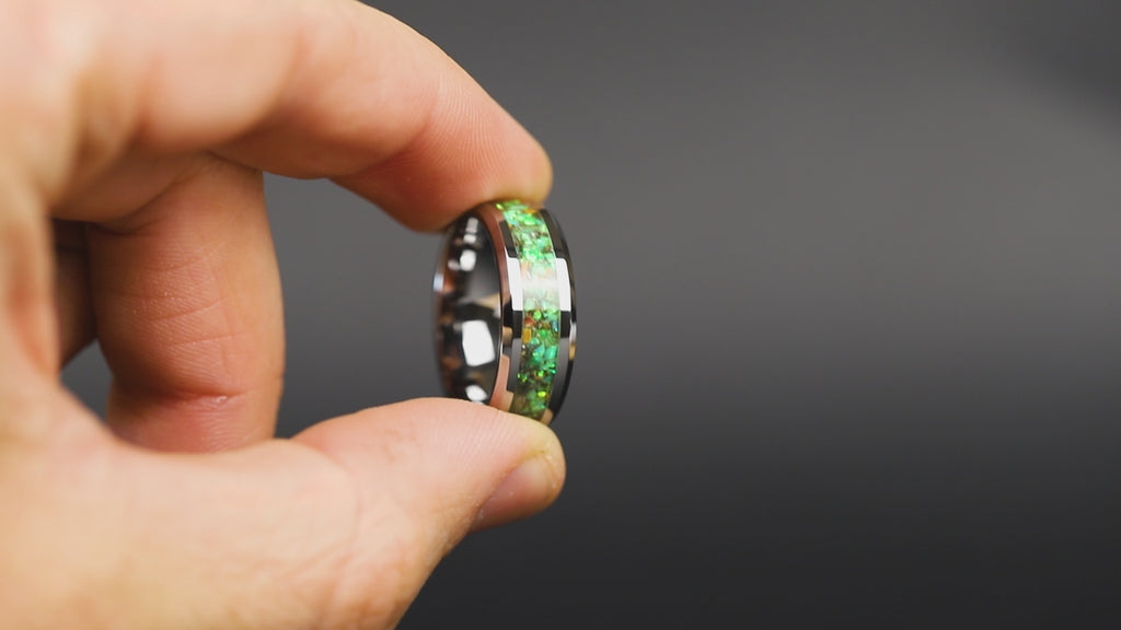360 degree product view of the Toxic Raptor Tungsten ring showing Velociraptor bone and Campo del Cielo meteorite shifting through lime green opal inlay transitioning to green glow in the dark