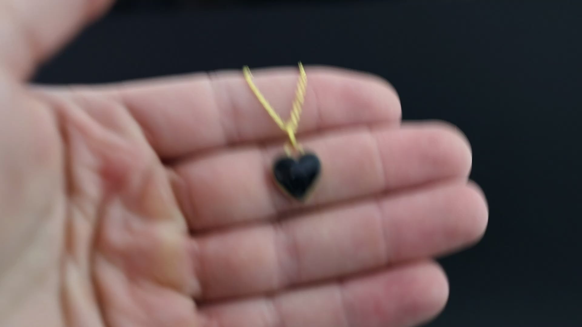 Video of the Dark Heart handcrafted black heart necklace in gold-plated sterling silver featuring authentic Campo Del Cielo meteorite and deep black resin inlay