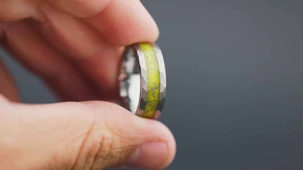 Cinematic view of the Solar Impact ring showing the Gibeon meteorite sparkle and yellow resin.